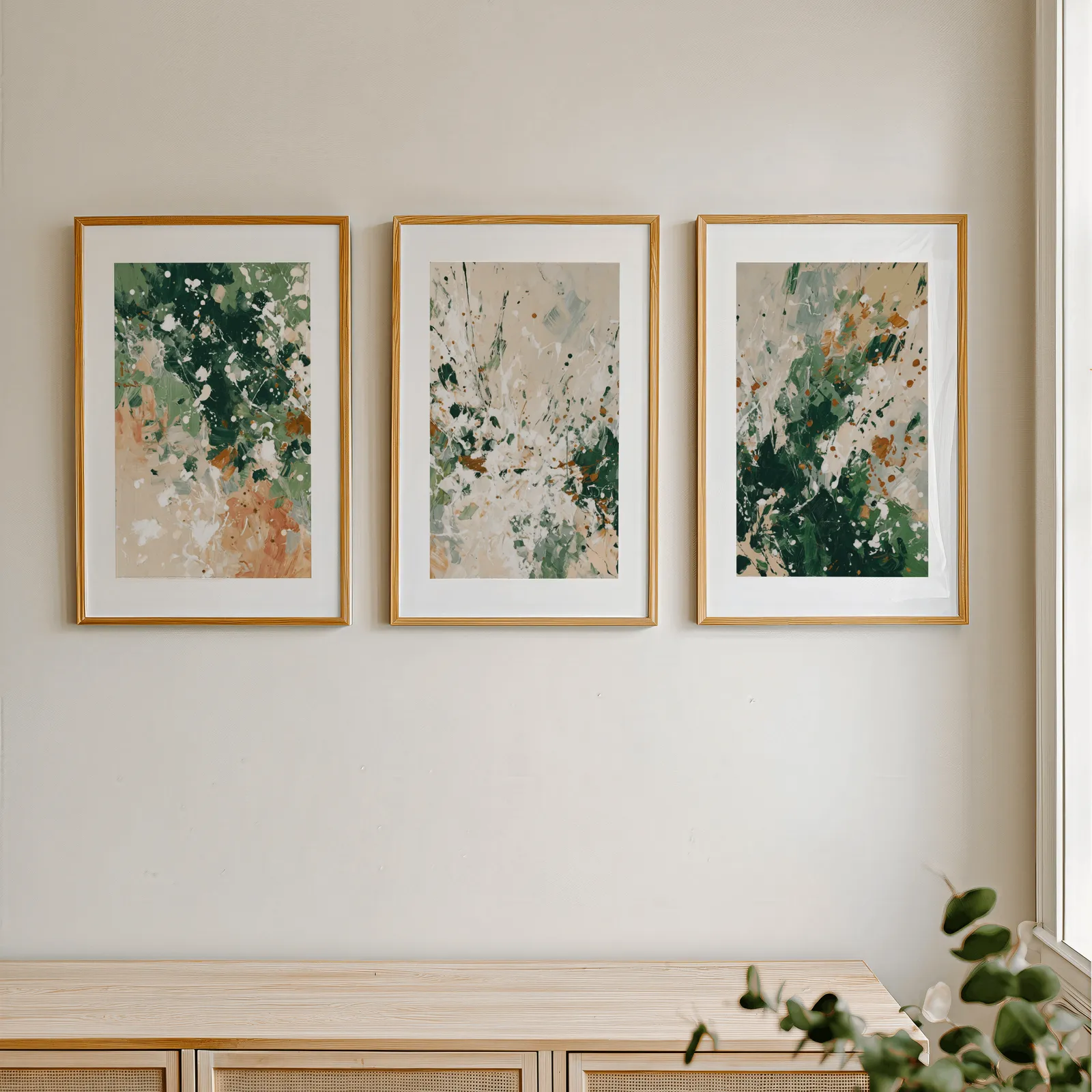 green terracotta abstract wall art set of three, in a row above a light wooden sideboard near a window