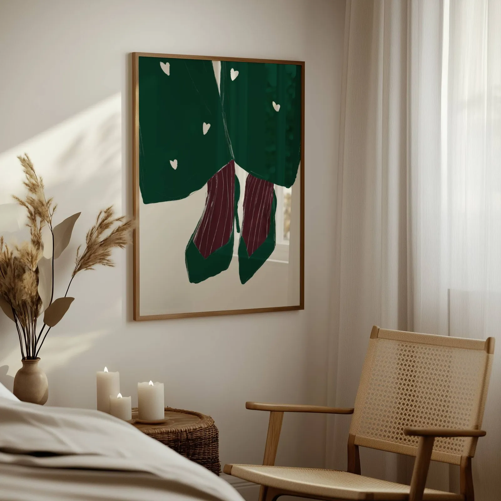 green heart pattern coat with burgundy heels wall art, above a woven side table with lit candles and pampas grass