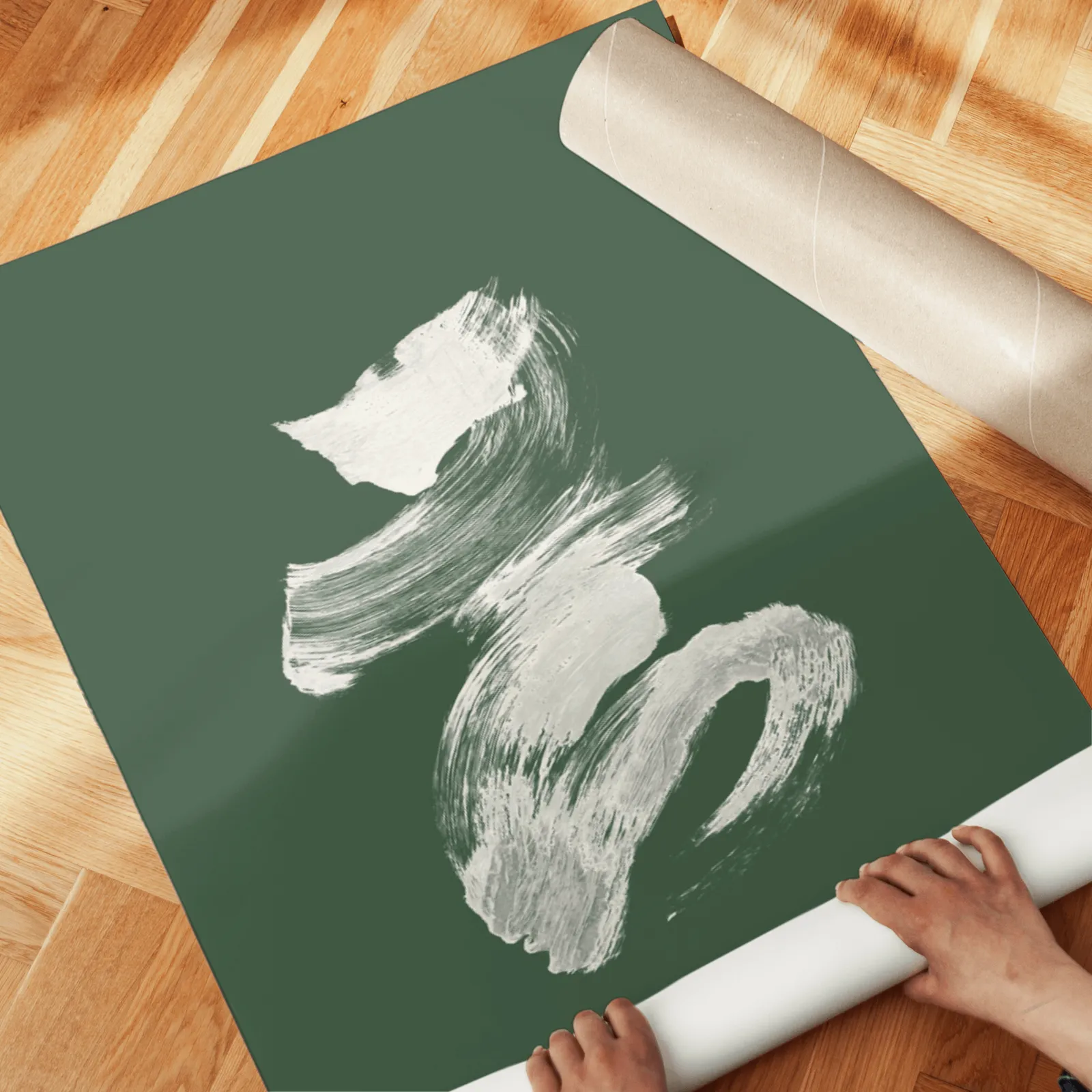 green and cream abstract brushstroke wall art set of 2, unrolled across a herringbone parquet floor by hand