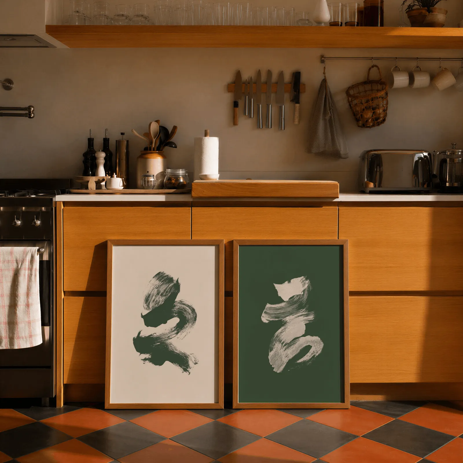 green and cream abstract brushstroke wall art set of 2, leaning against wooden cabinets on terracotta tiled floor