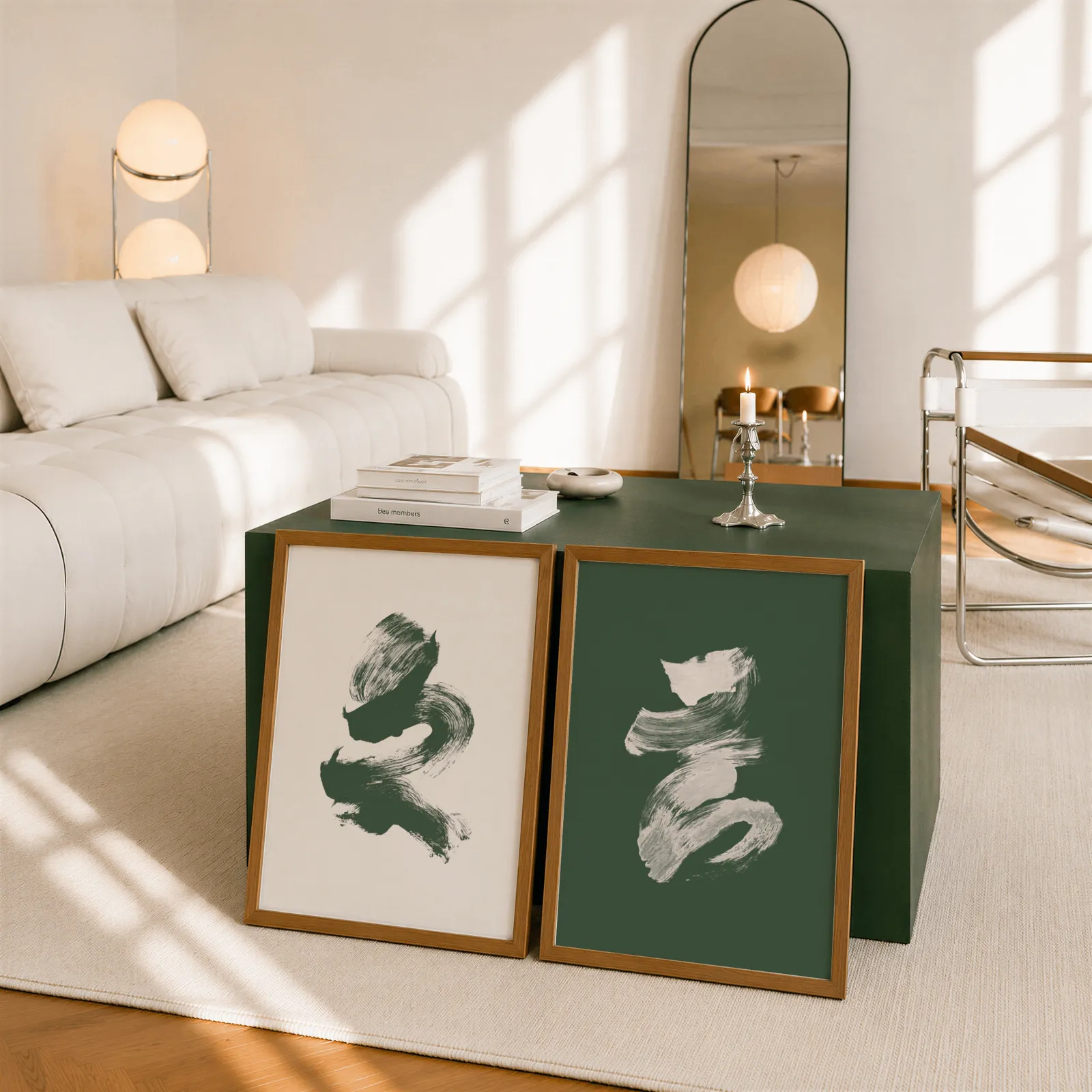 green and cream abstract brushstroke wall art set of 2, leaning against a dark green cube table beside an arched mirror
