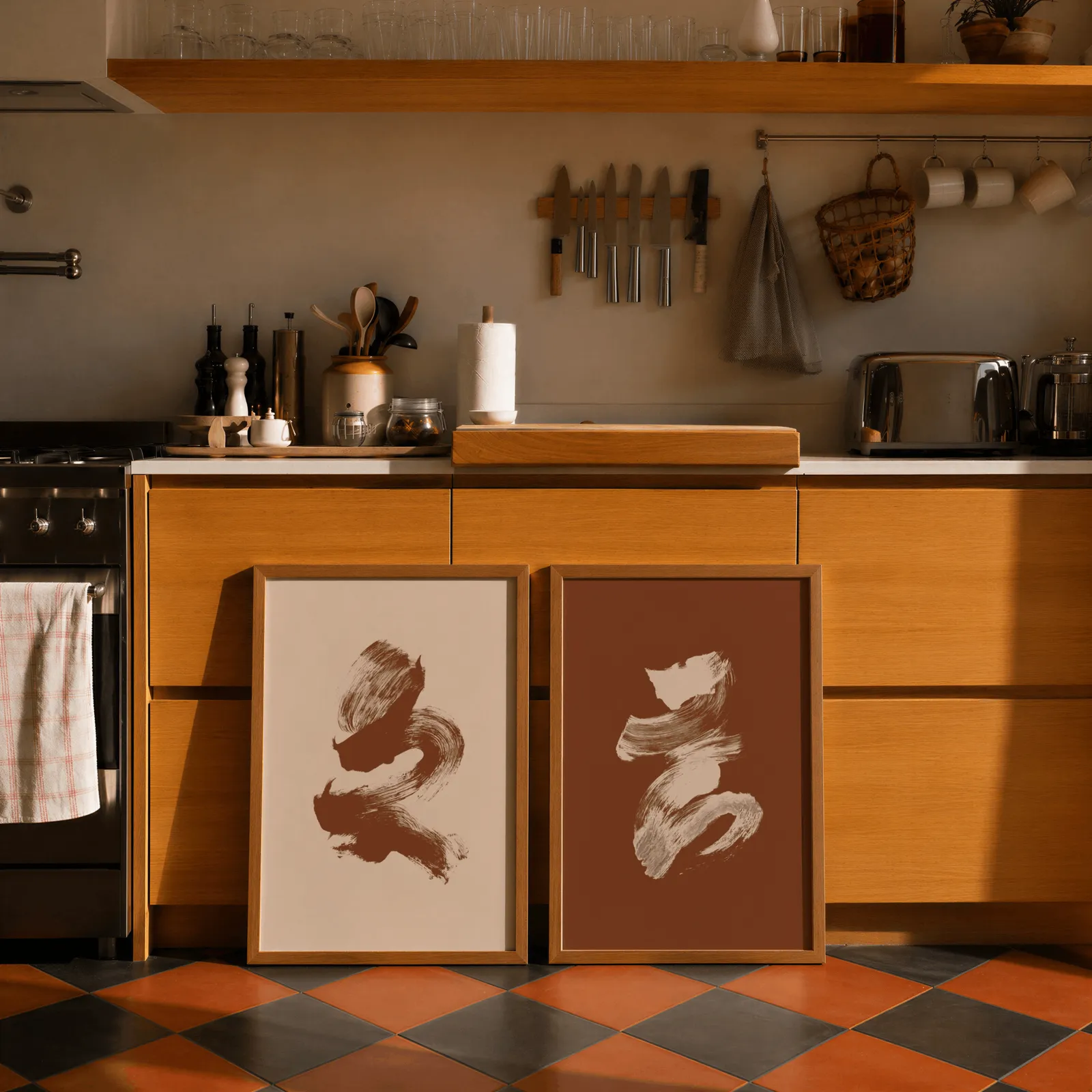 terracotta abstract brushstroke wall art set of 2, leaning against wooden cabinets on terracotta tiled floor