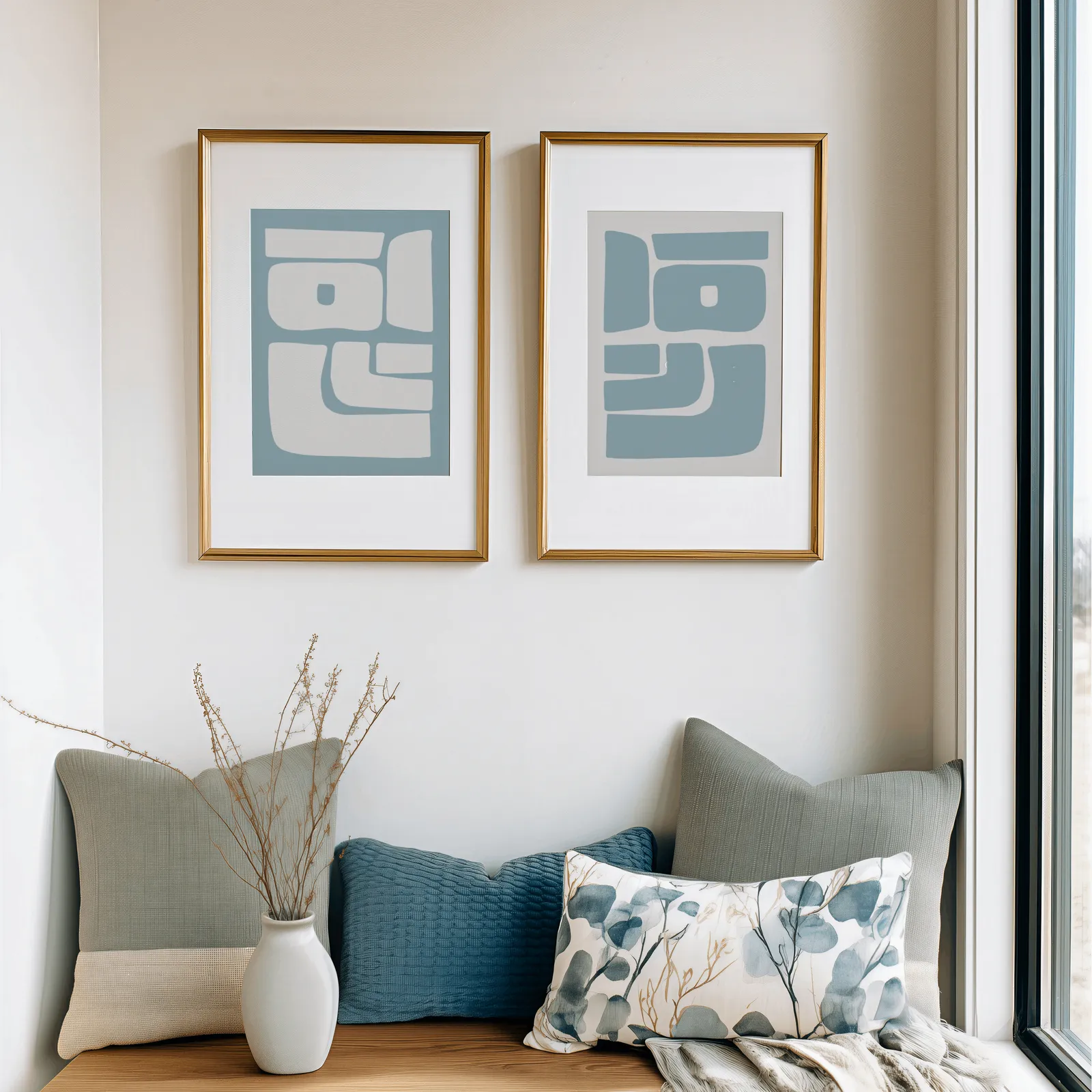 blue abstract minimalist wall art set of 2, above a cushioned window seat with sage and blue pillows