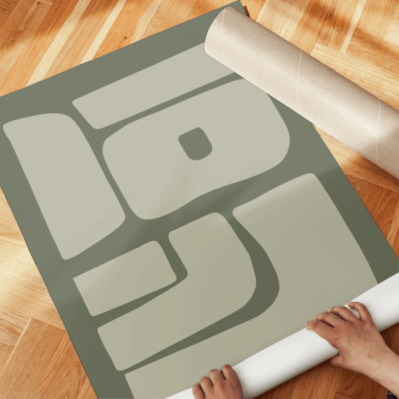 green abstract minimalist wall art set of two, unrolled across a herringbone parquet floor by hand