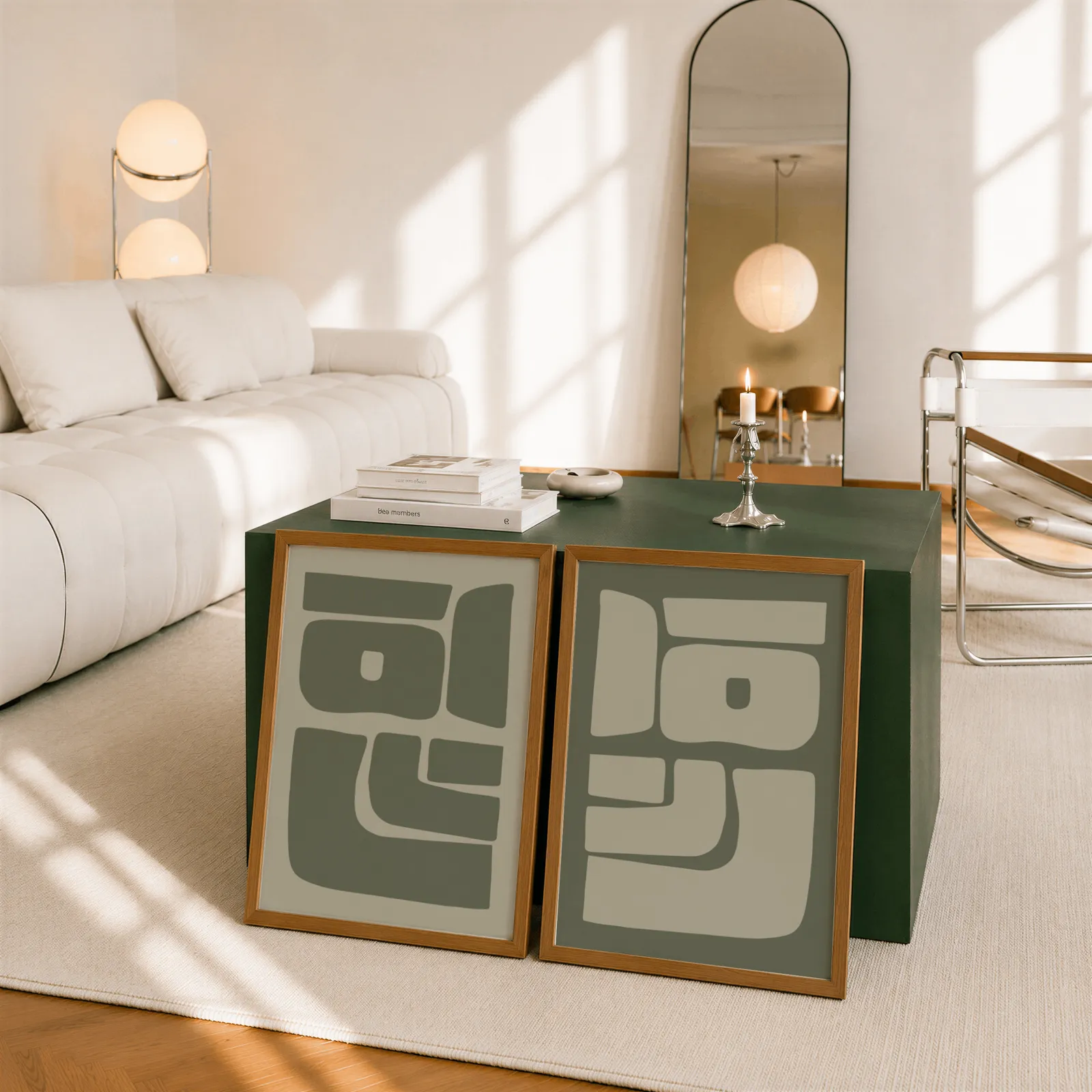 green abstract minimalist wall art set of two, leaning against a dark green cube table beside an arched mirror