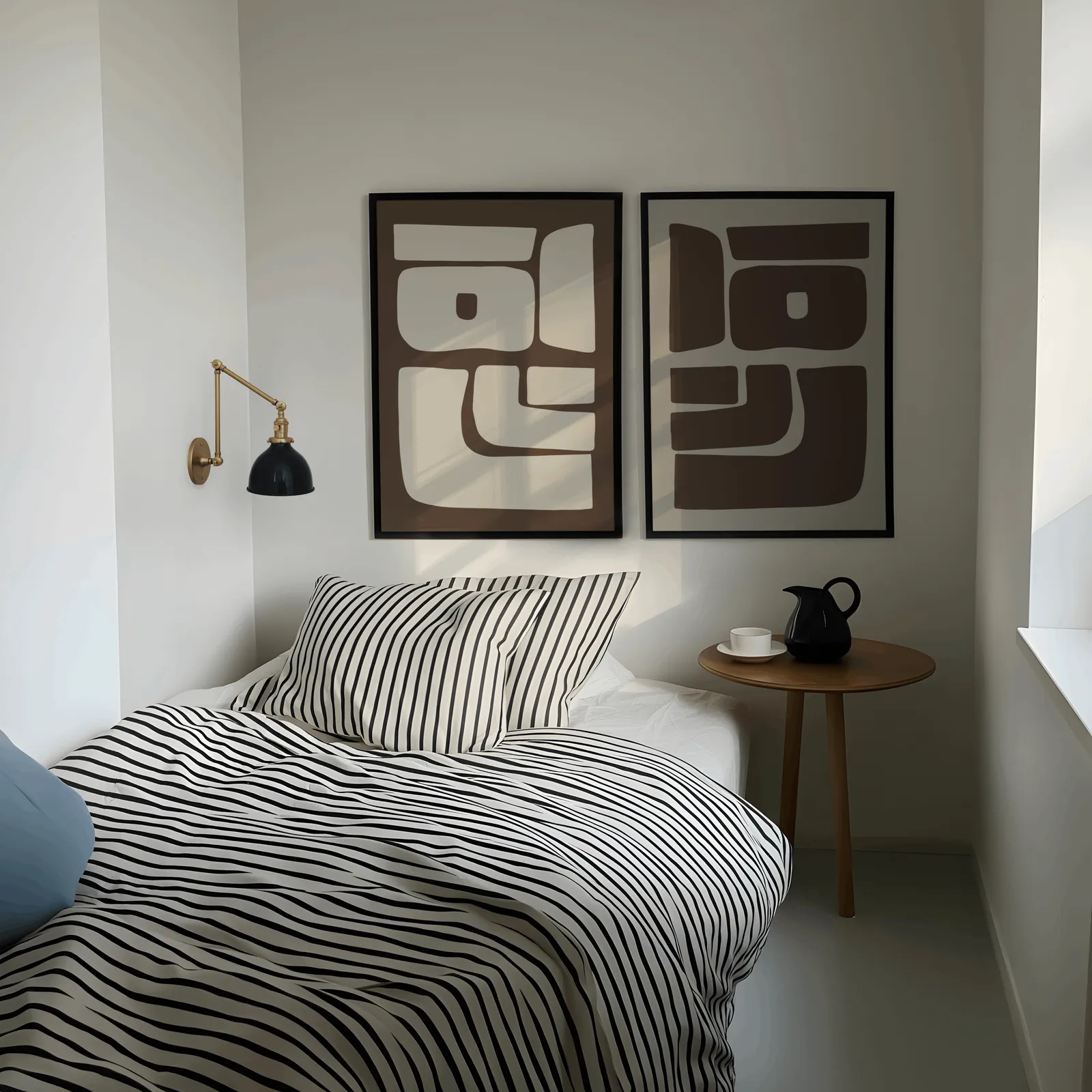 brown beige abstract mid-century wall art set of 2, above a striped bed beside a brass swing-arm lamp
