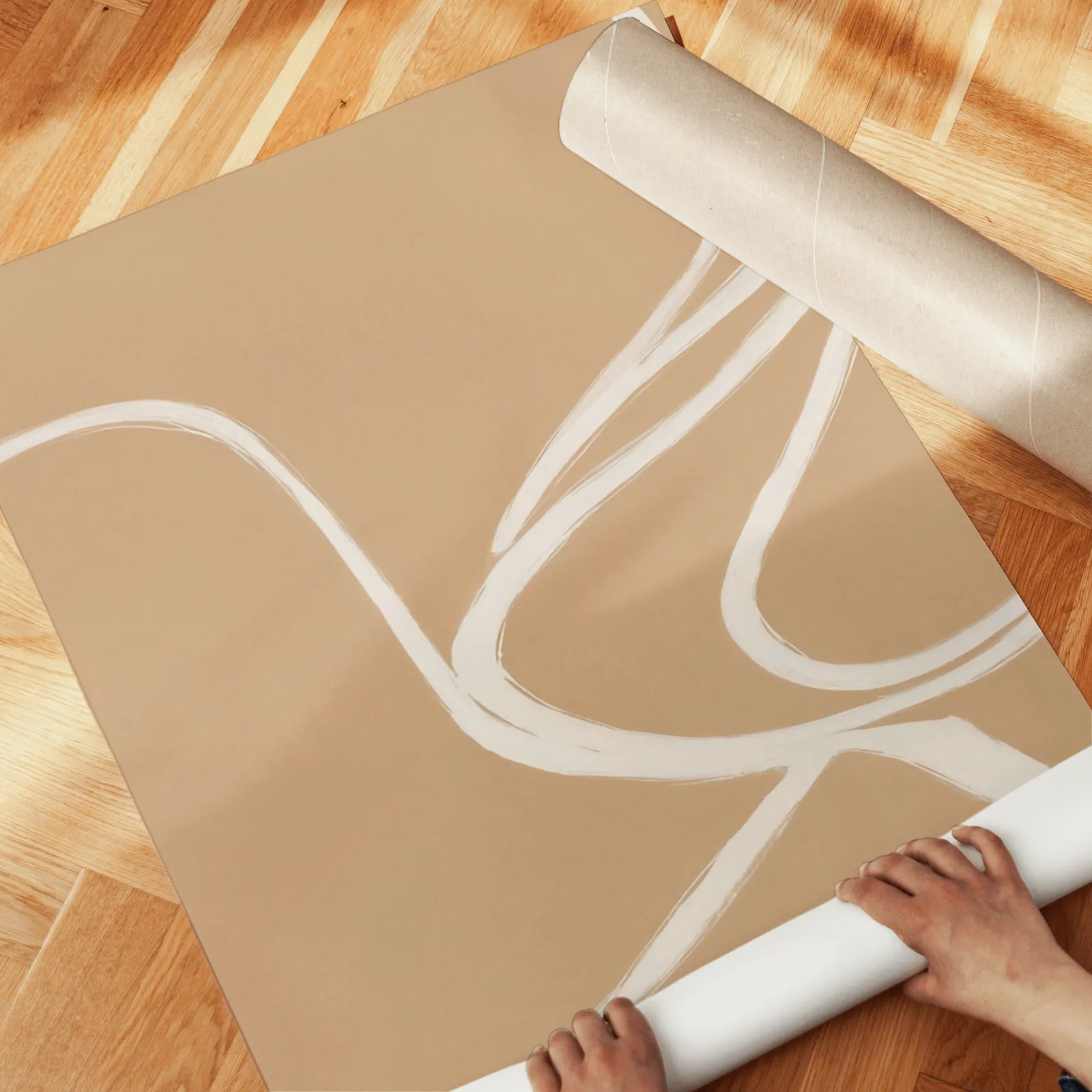 beige abstract minimalist wall art set of three, unrolled across a herringbone wood floor by hand