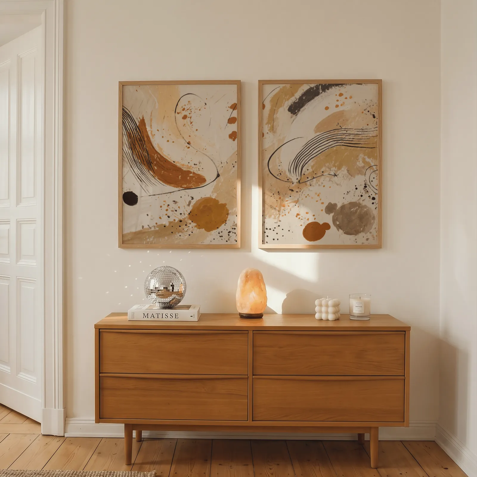 terracotta abstract wall art set of 2, above a wooden dresser with a salt lamp and disco ball
