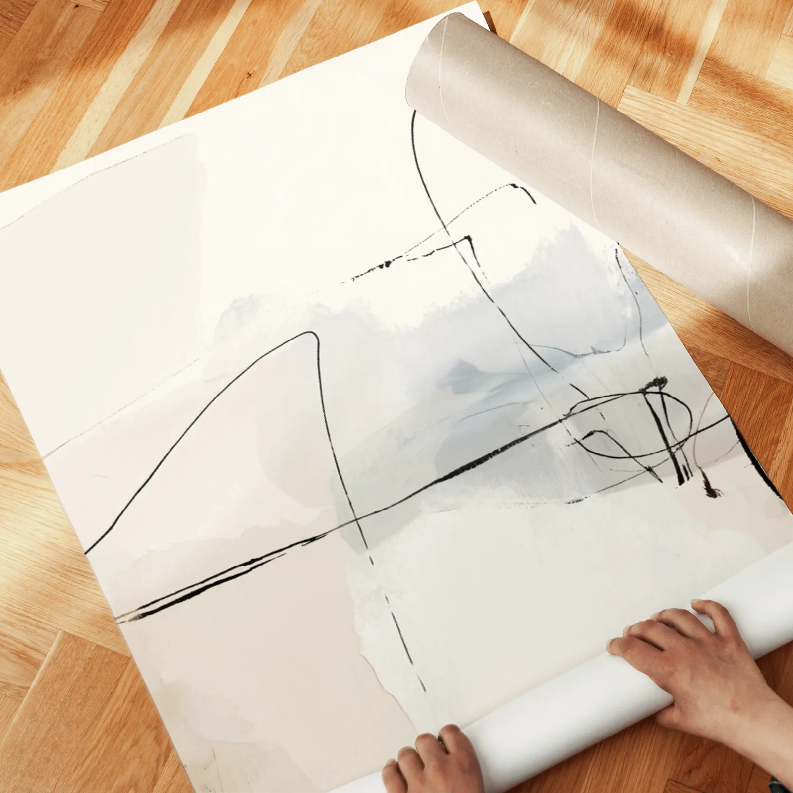 neutral abstract minimalist wall art set of three, unrolled across a herringbone wood floor by hand