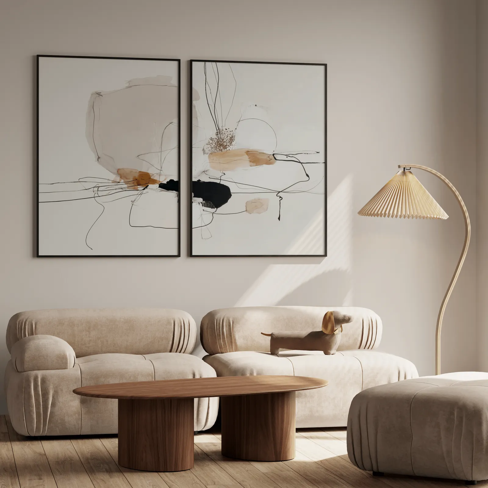 beige abstract minimalist wall art set of two, above a plush beige sofa with a pleated lamp nearby
