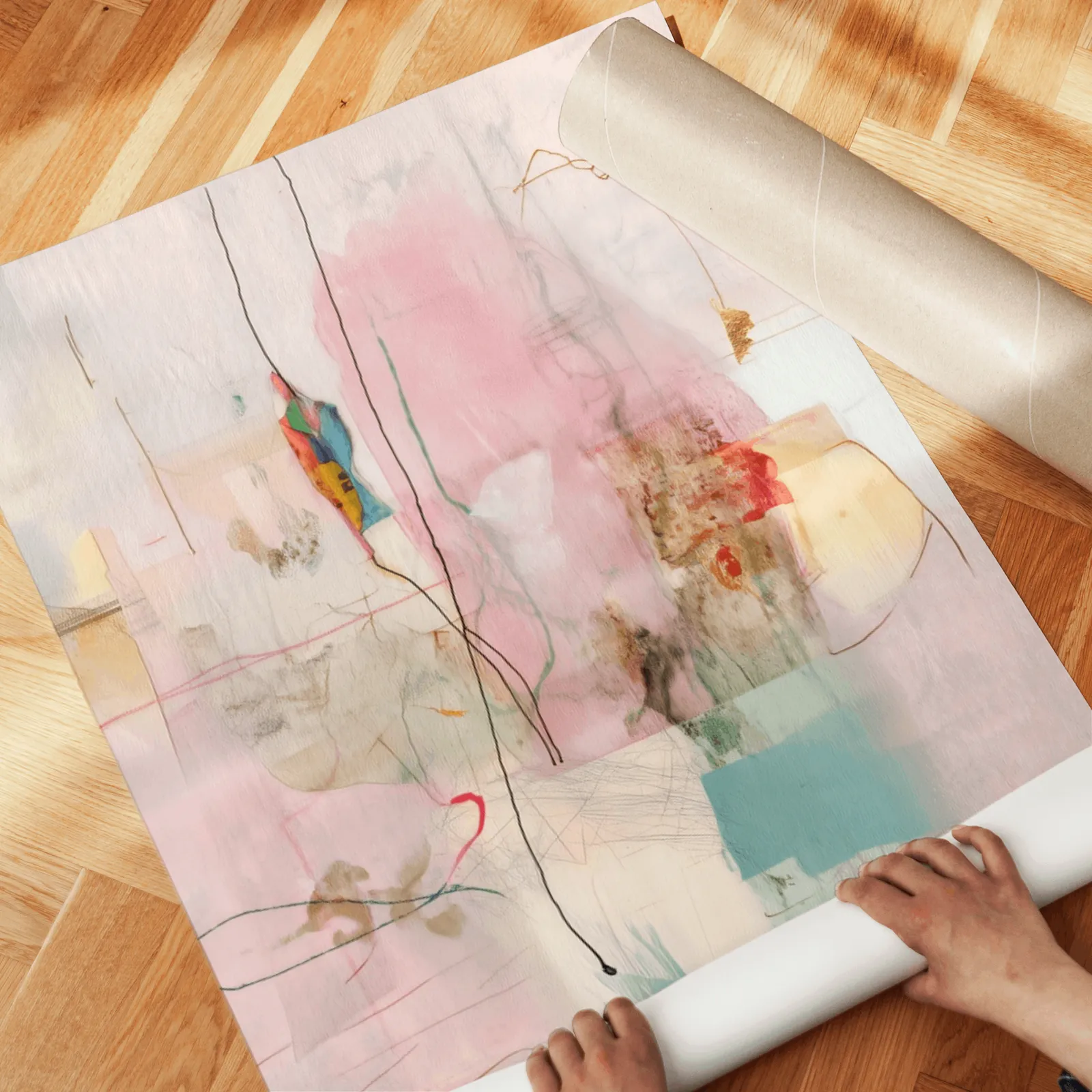 pink and yellow abstract wall art set of two, unrolled across a herringbone parquet floor by hand