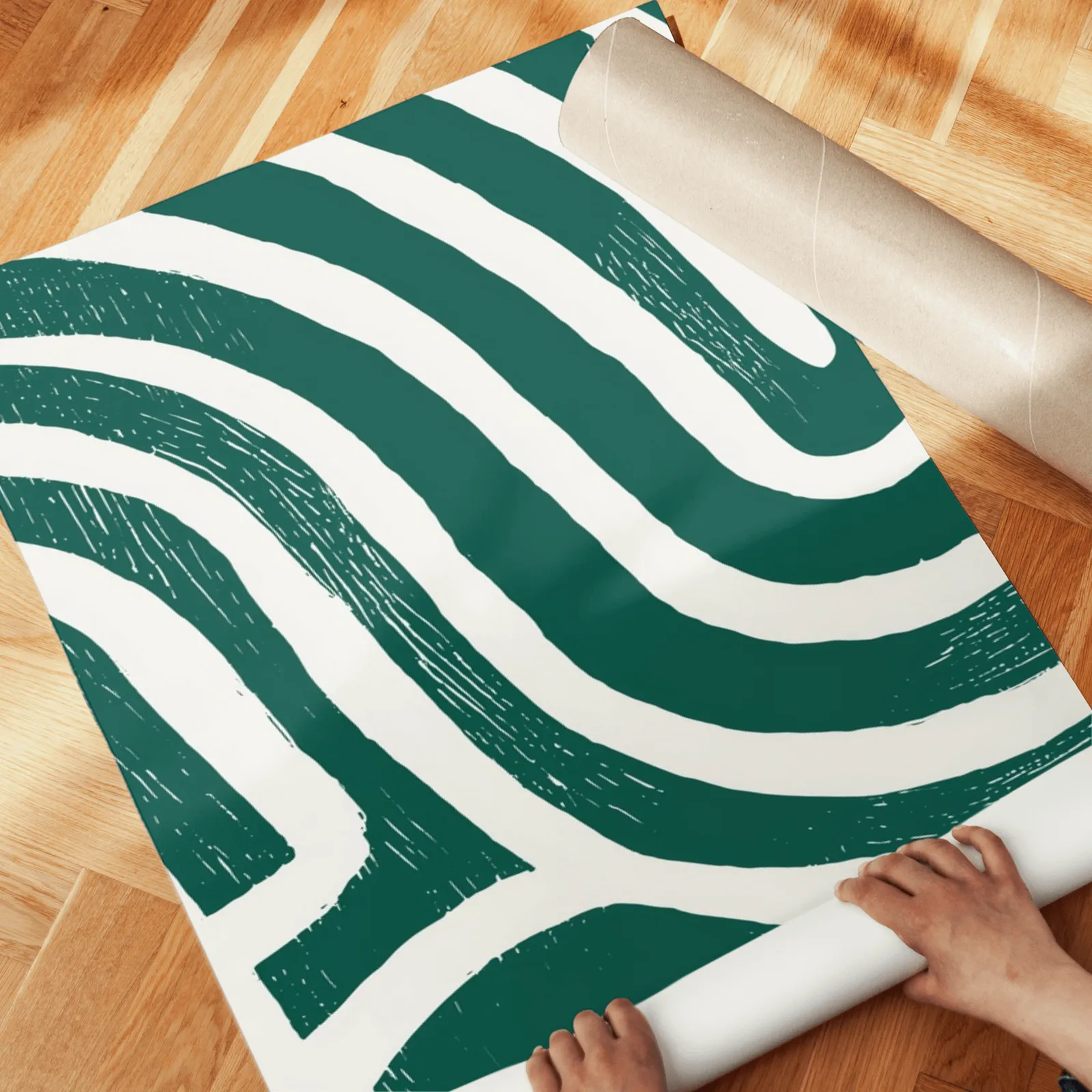 green abstract maze line triptych wall art, unrolled across a herringbone wood floor by hand