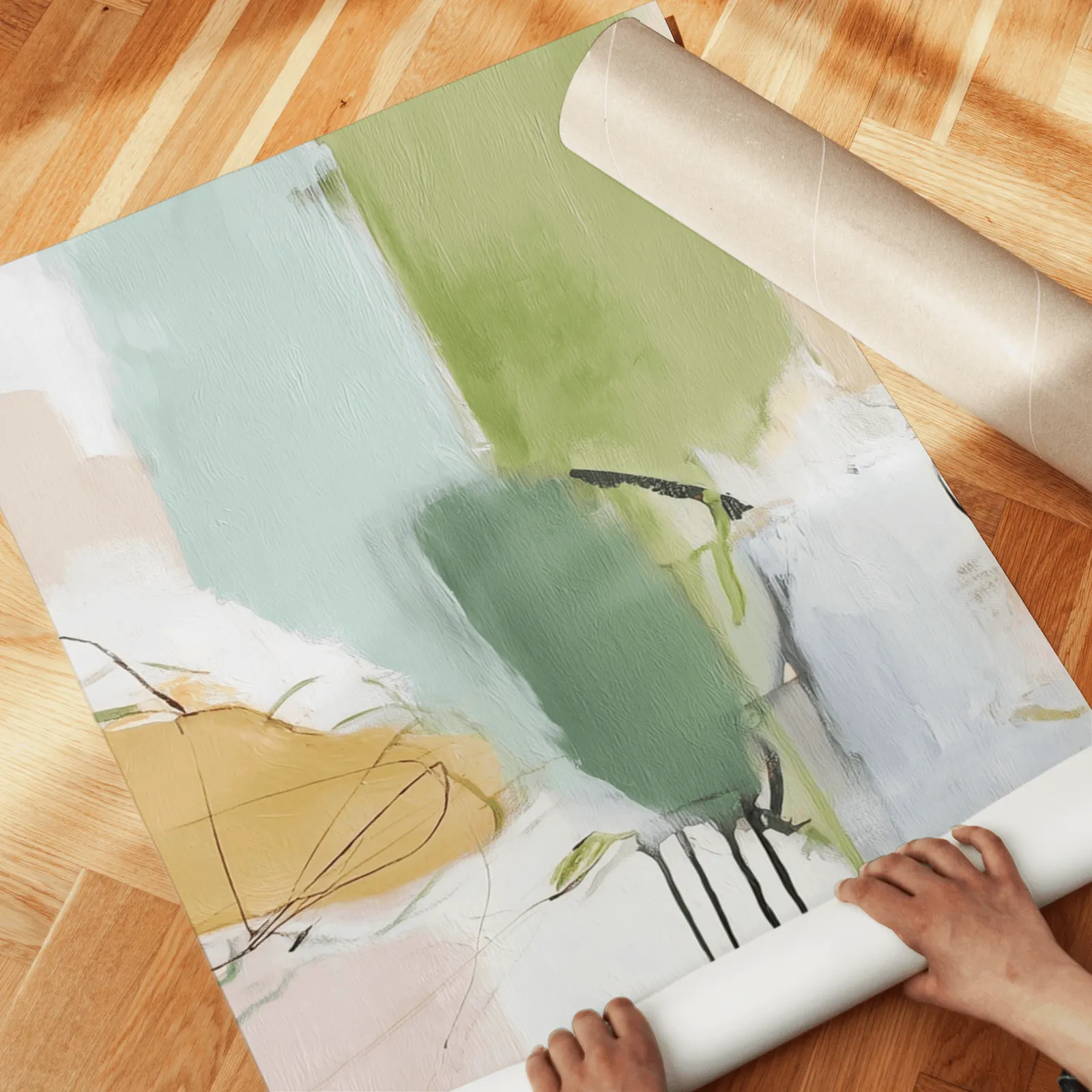 green abstract set of 3 wall art panels, unrolled across a herringbone wood floor by hand