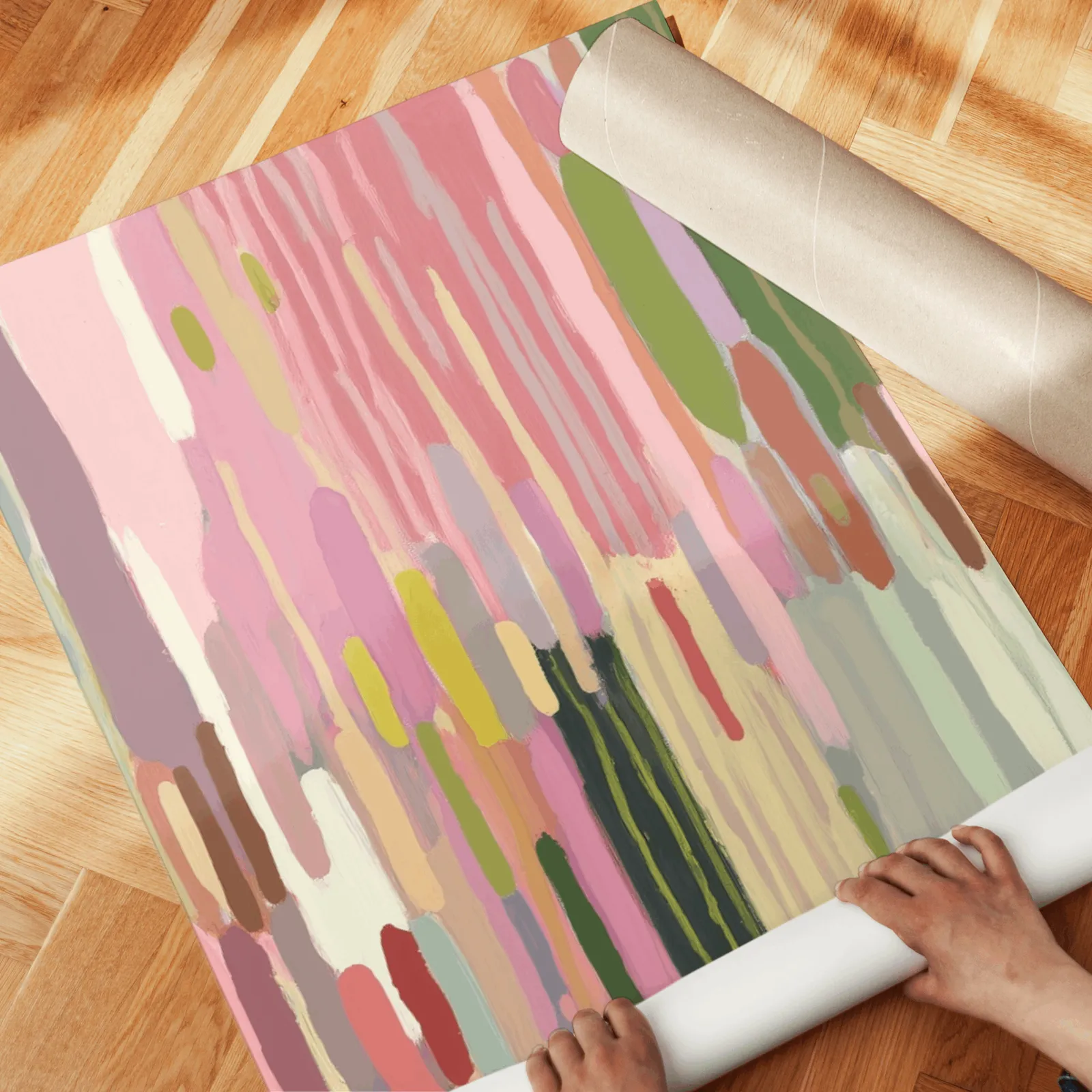 colorful abstract wall art set of 3, unrolled across a herringbone wood floor by hand