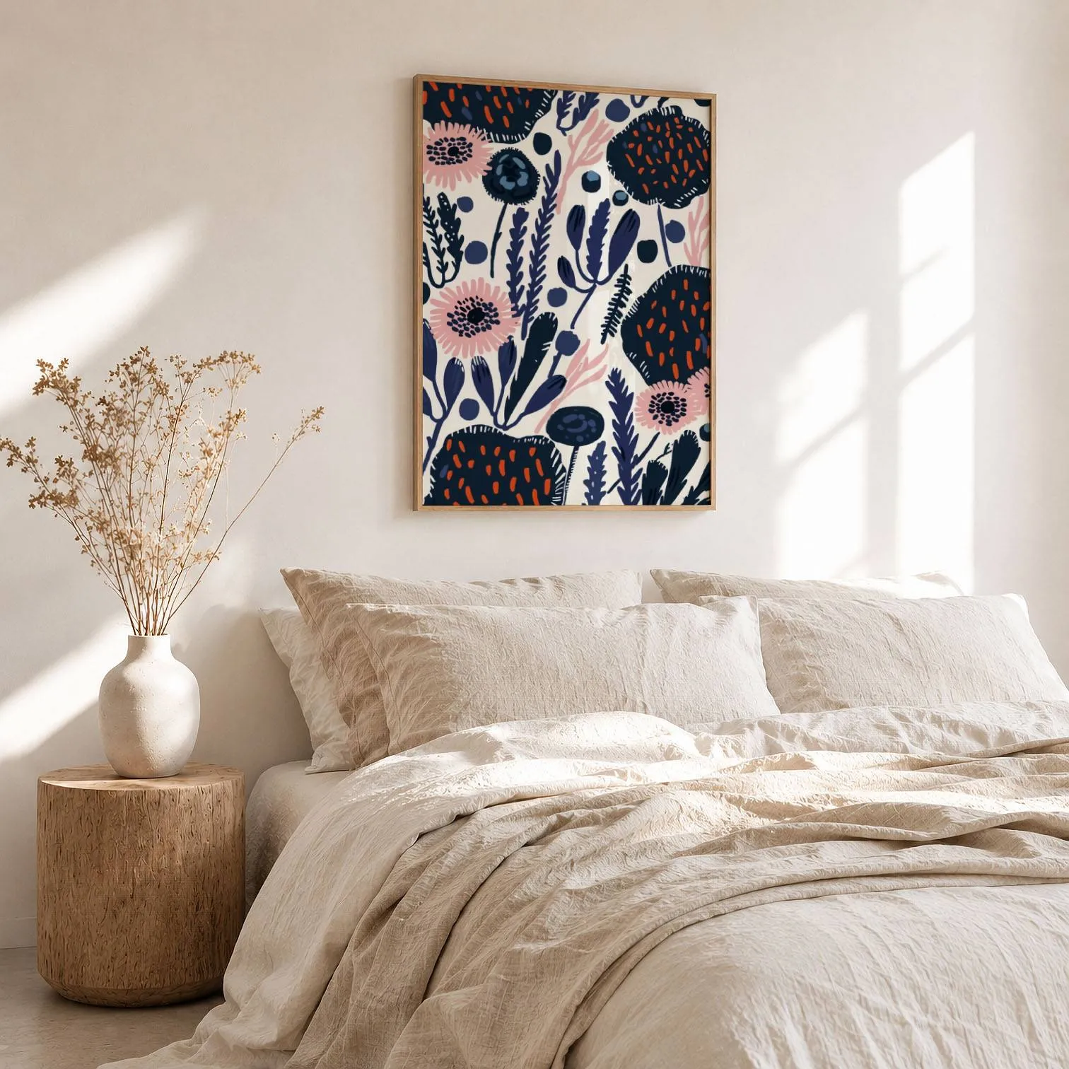 navy blue floral botanical wall art, above a rumpled linen bed beside a stump side table