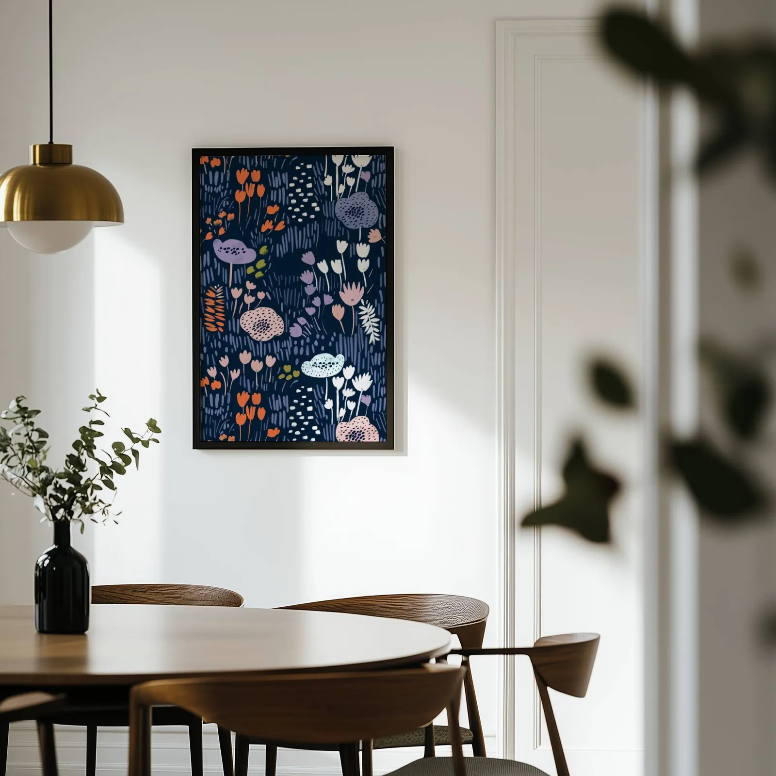 navy floral botanical wall art print, on a white wall above a round wooden dining table