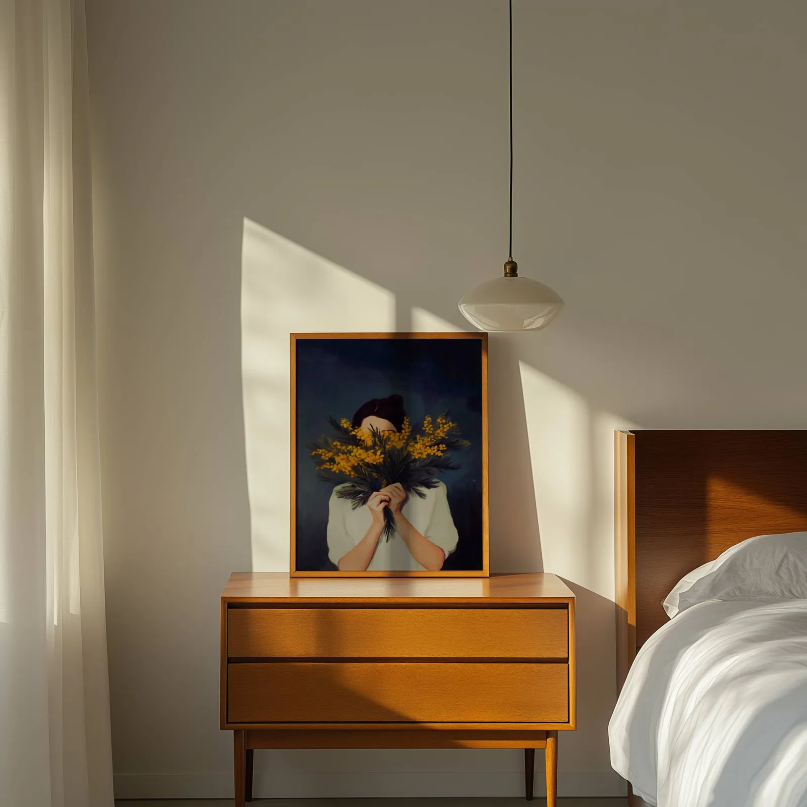 woman with yellow mimosa flowers wall art, propped on a wooden dresser beside a pendant lamp