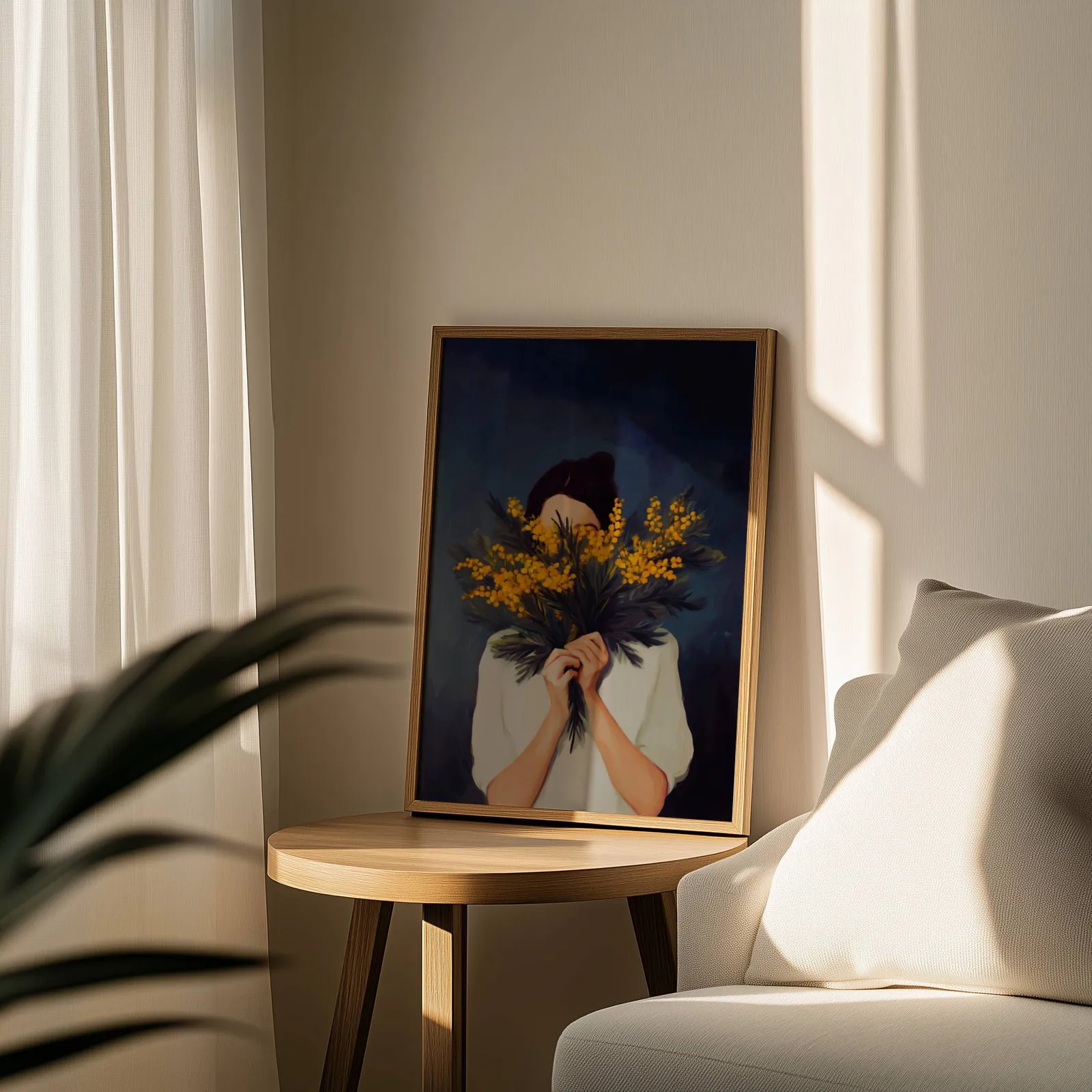 woman with yellow mimosa flowers wall art, leaning on a round wooden side table by a sheer curtain