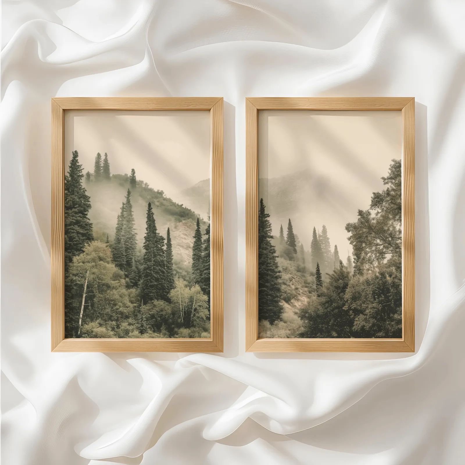 misty forest wall art set of two pine hillside prints, side by side atop rumpled white silky fabric