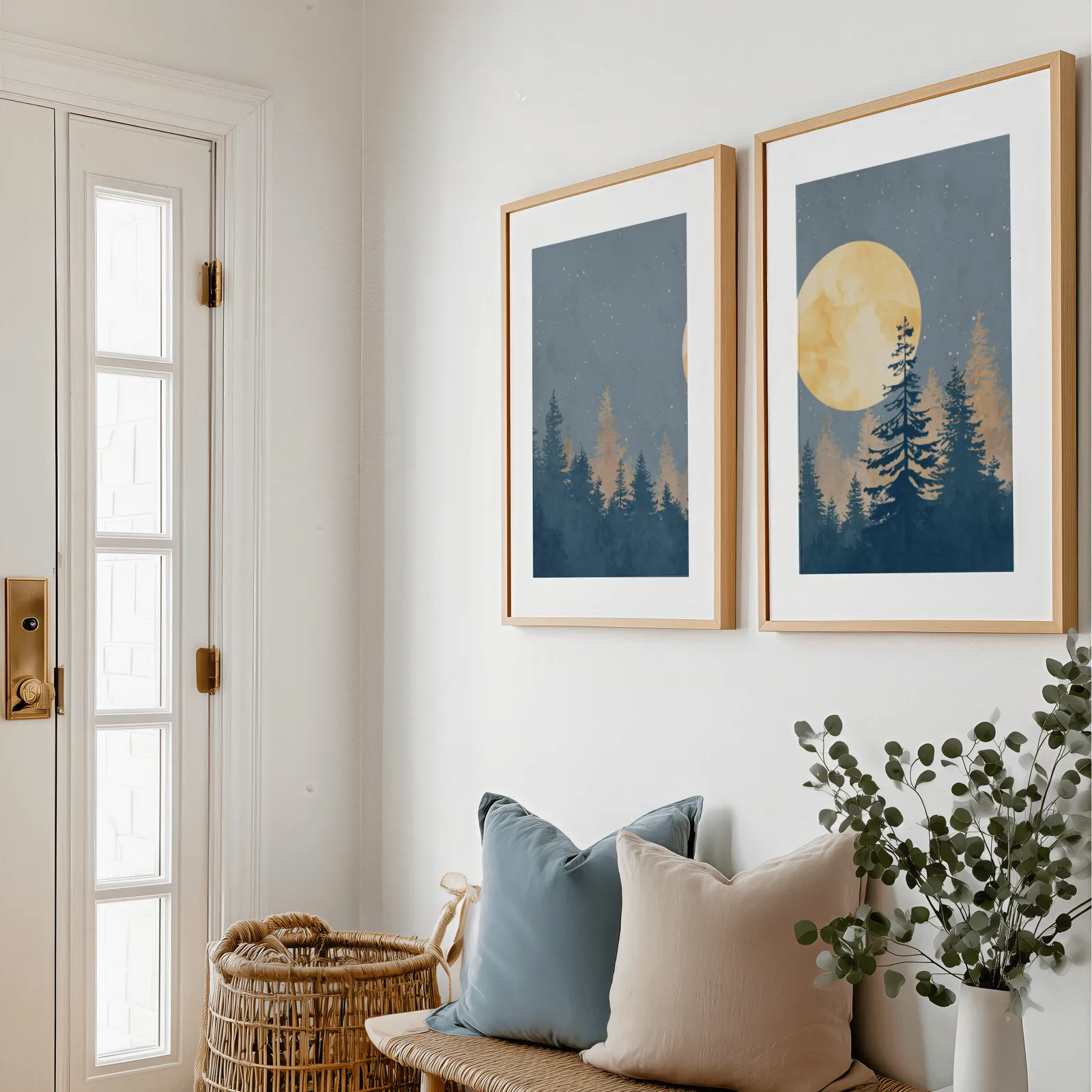 blue pine tree wall art set with golden moon, above a bench with blue and blush pillows near the entry door