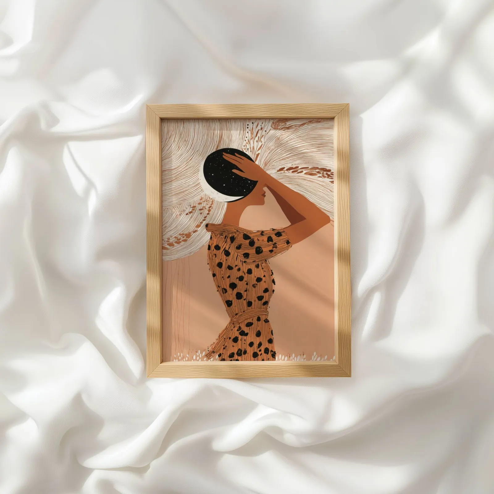 terracotta boho woman with moon wall art, resting atop rumpled white silky fabric