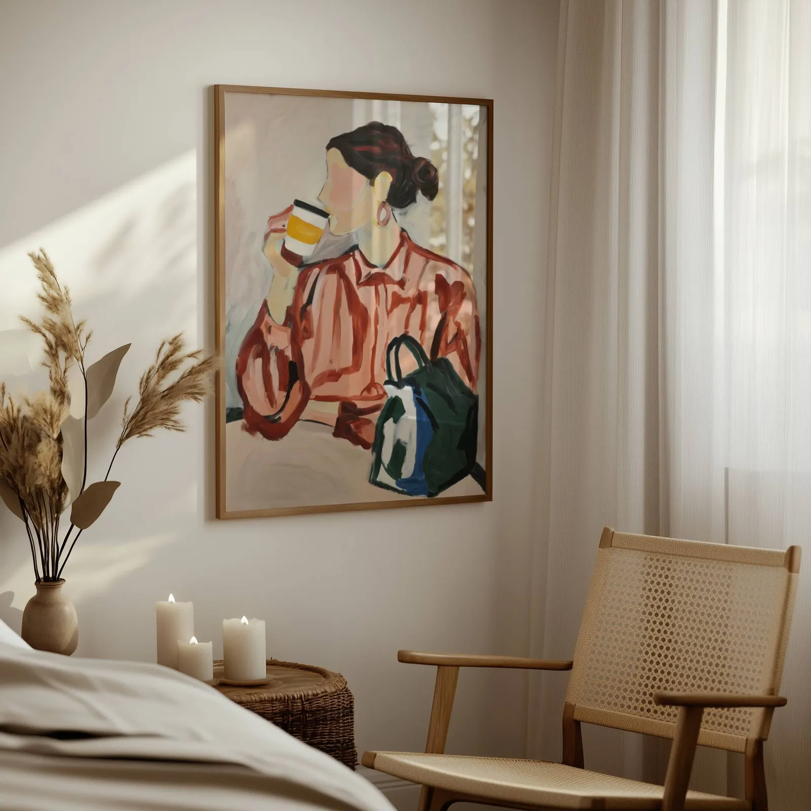 woman drinking coffee modern portrait wall art, above a woven side table with lit candles and pampas grass