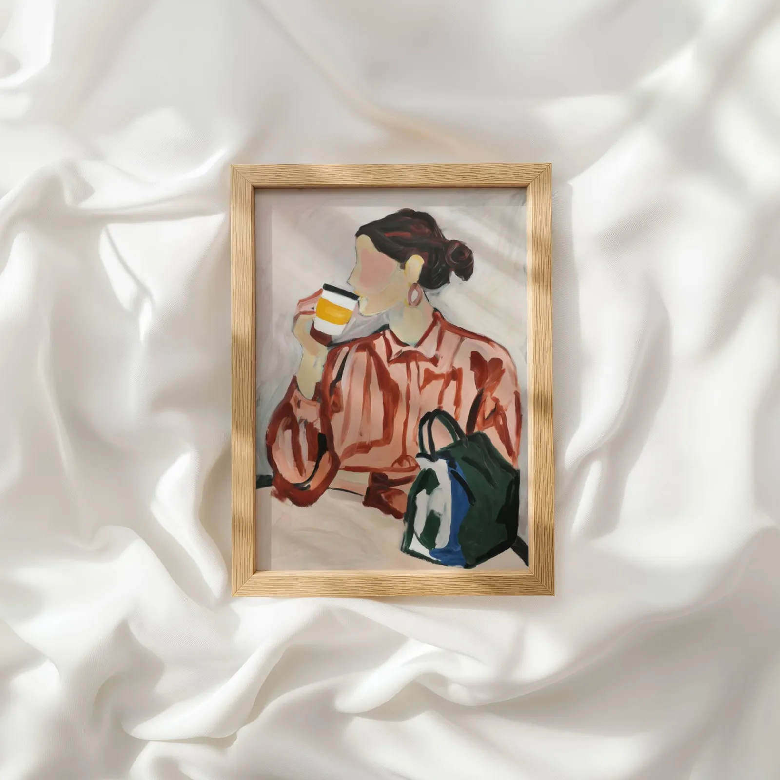 woman drinking coffee modern portrait wall art, resting atop rumpled white silky fabric