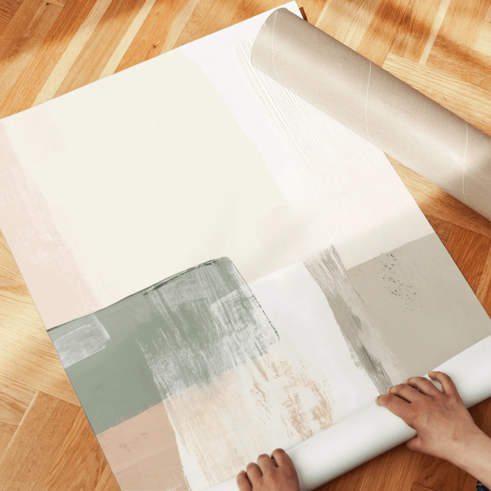 neutral abstract triptych wall art in green and terracotta, unrolled across a herringbone wood floor by hand