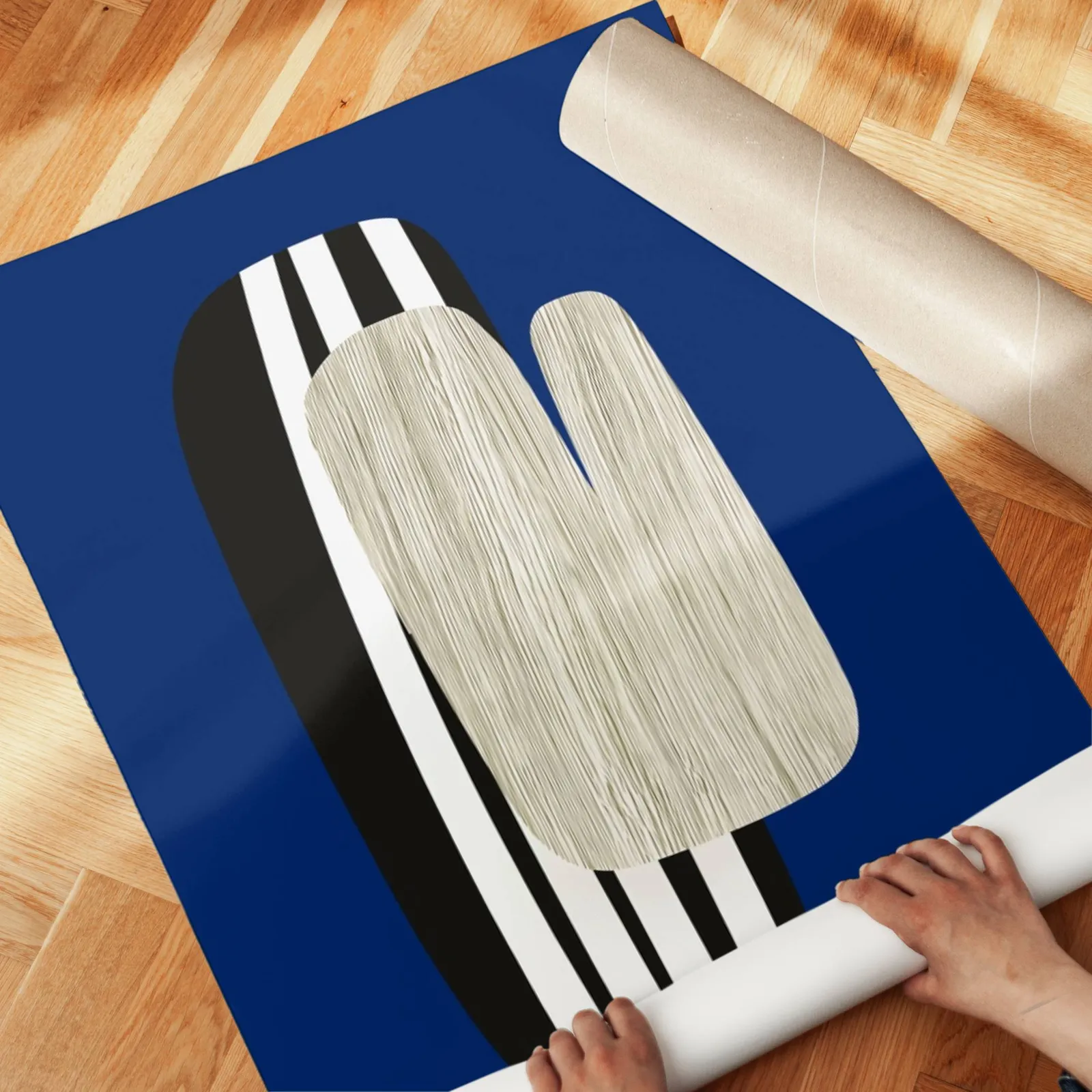 navy blue abstract wall art, unrolled across a herringbone parquet floor by hand