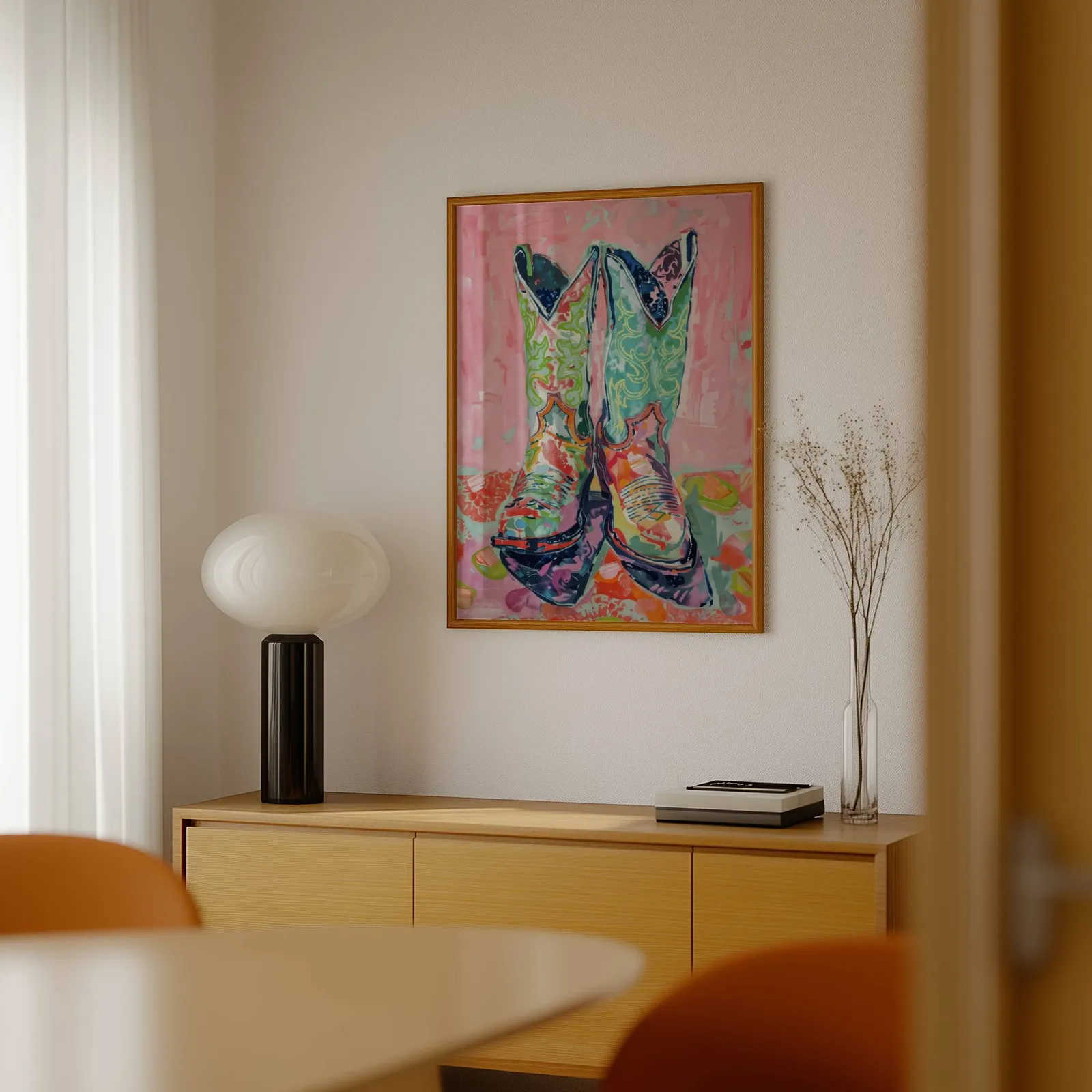 colorful cowgirl boots western wall art, above a light wood sideboard beside a bulbous black lamp