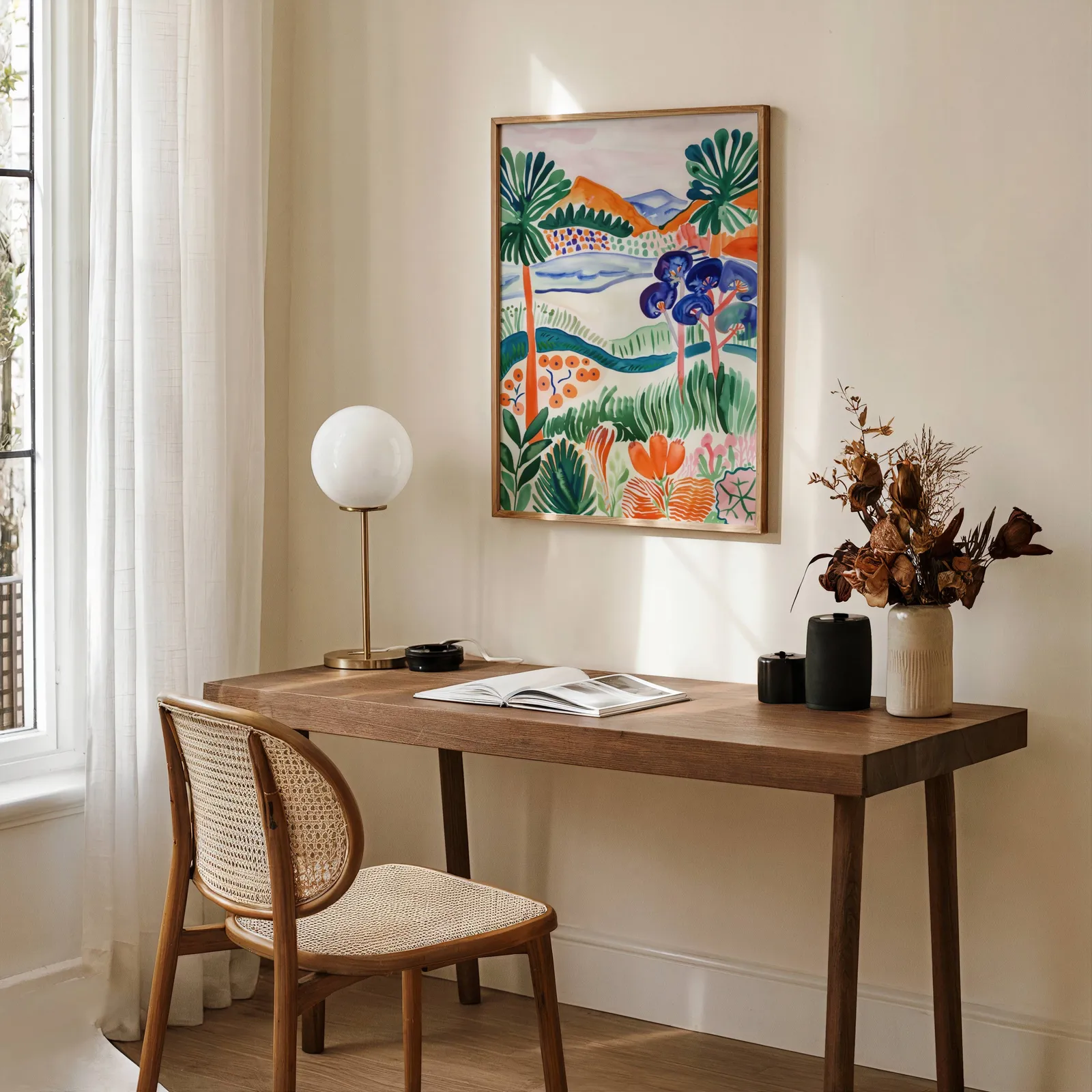 colorful landscape wall art with botanical garden scene, above a wooden desk with a globe lamp and dried flowers