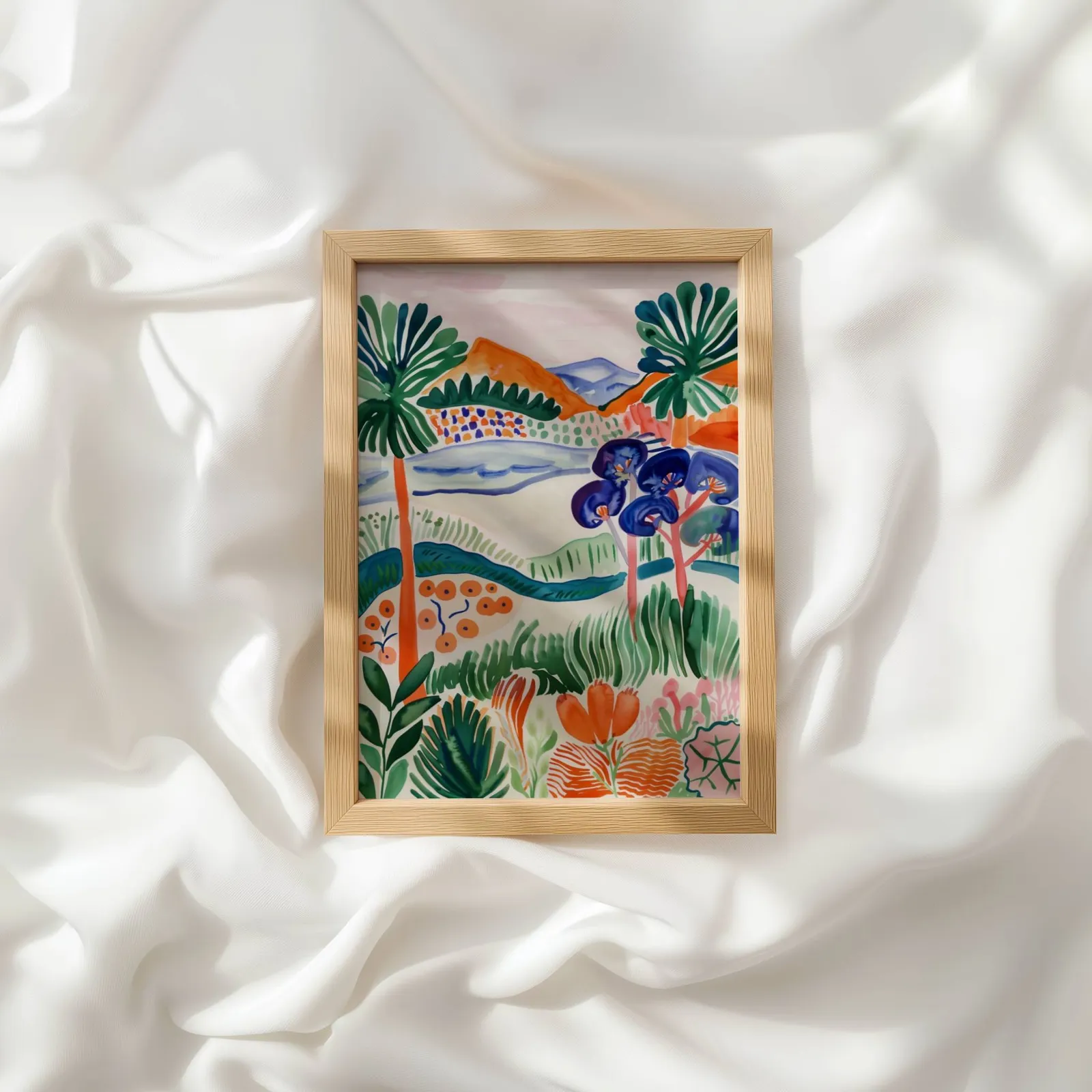 colorful landscape wall art with botanical garden scene, resting atop rumpled white silky fabric