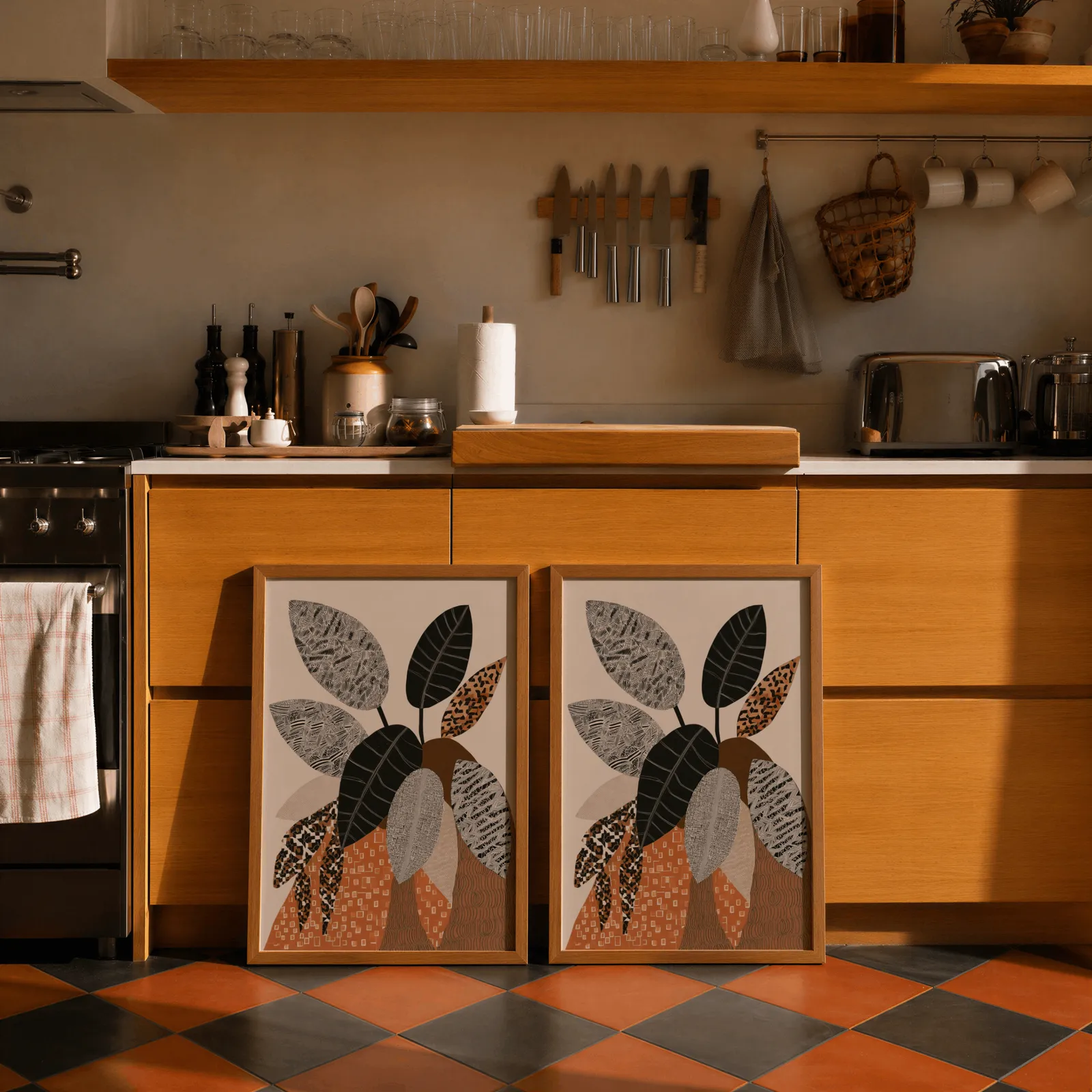 terracotta botanical wall art set of 2 patterned leaves, leaning against wooden cabinets on terracotta tiled floor