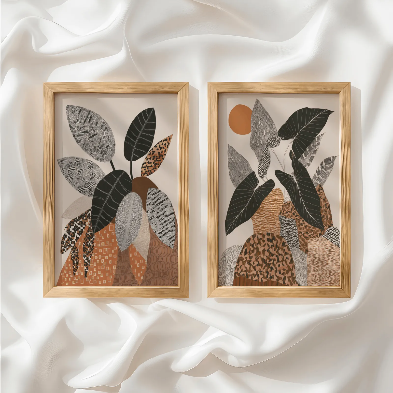 terracotta botanical wall art set of 2 patterned leaves, side by side atop rumpled white silky fabric