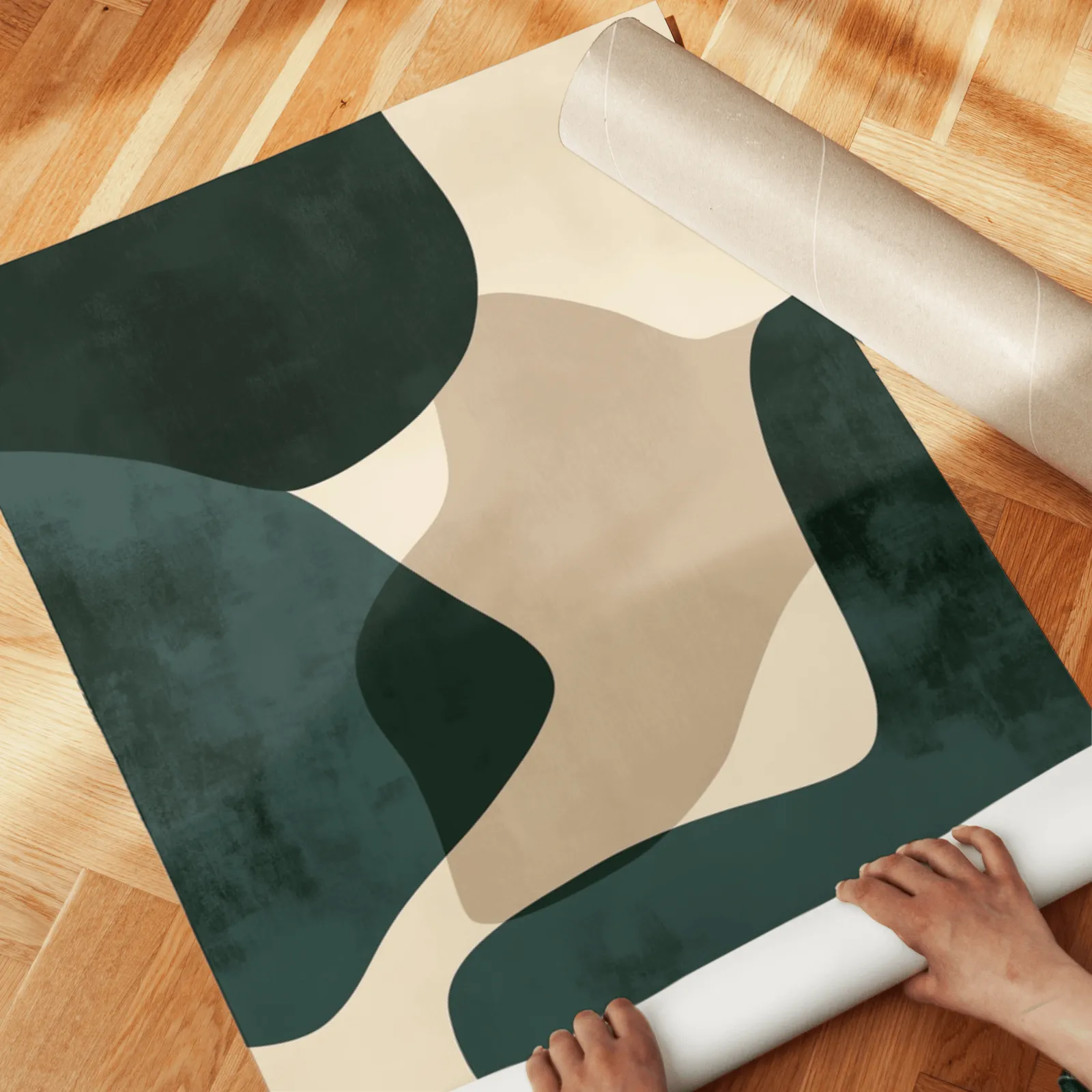green and beige abstract wall art set of two, unrolled across a herringbone parquet floor by hand