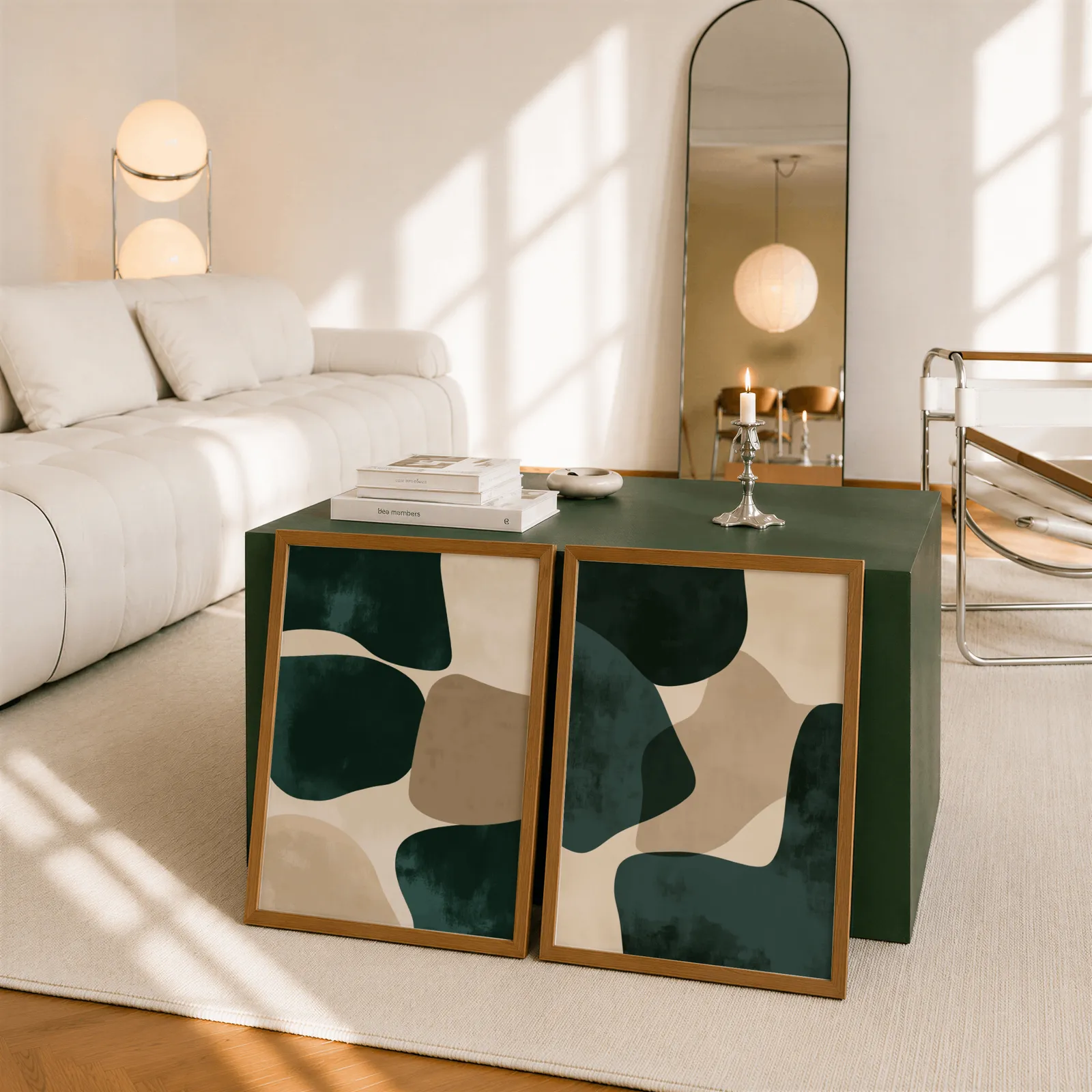 green and beige abstract wall art set of two, leaning against a dark green cube table beside an arched mirror