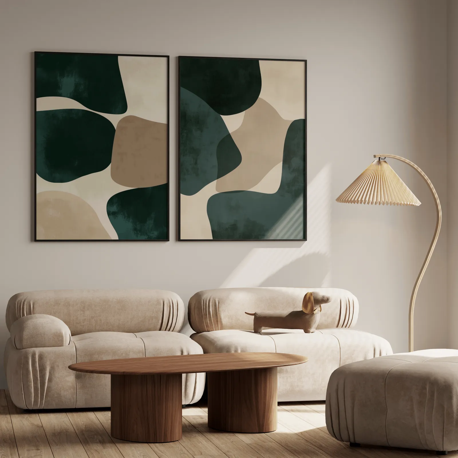 green and beige abstract wall art set of two, above a plush beige sofa with a pleated lamp nearby