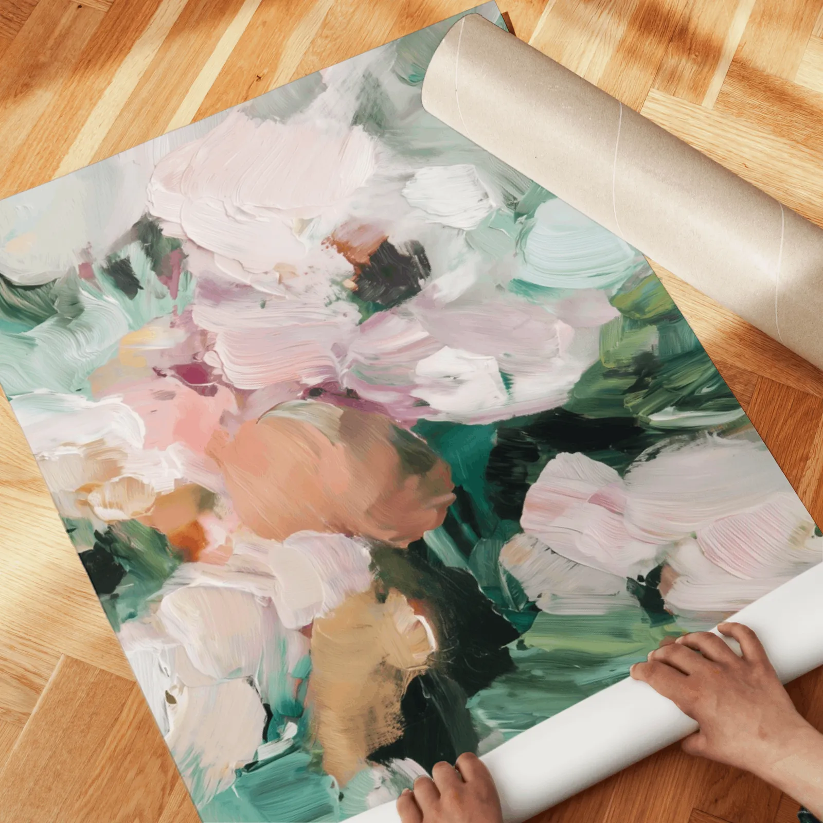 pink and green abstract floral wall art set of two, unrolled across a herringbone parquet floor by hand