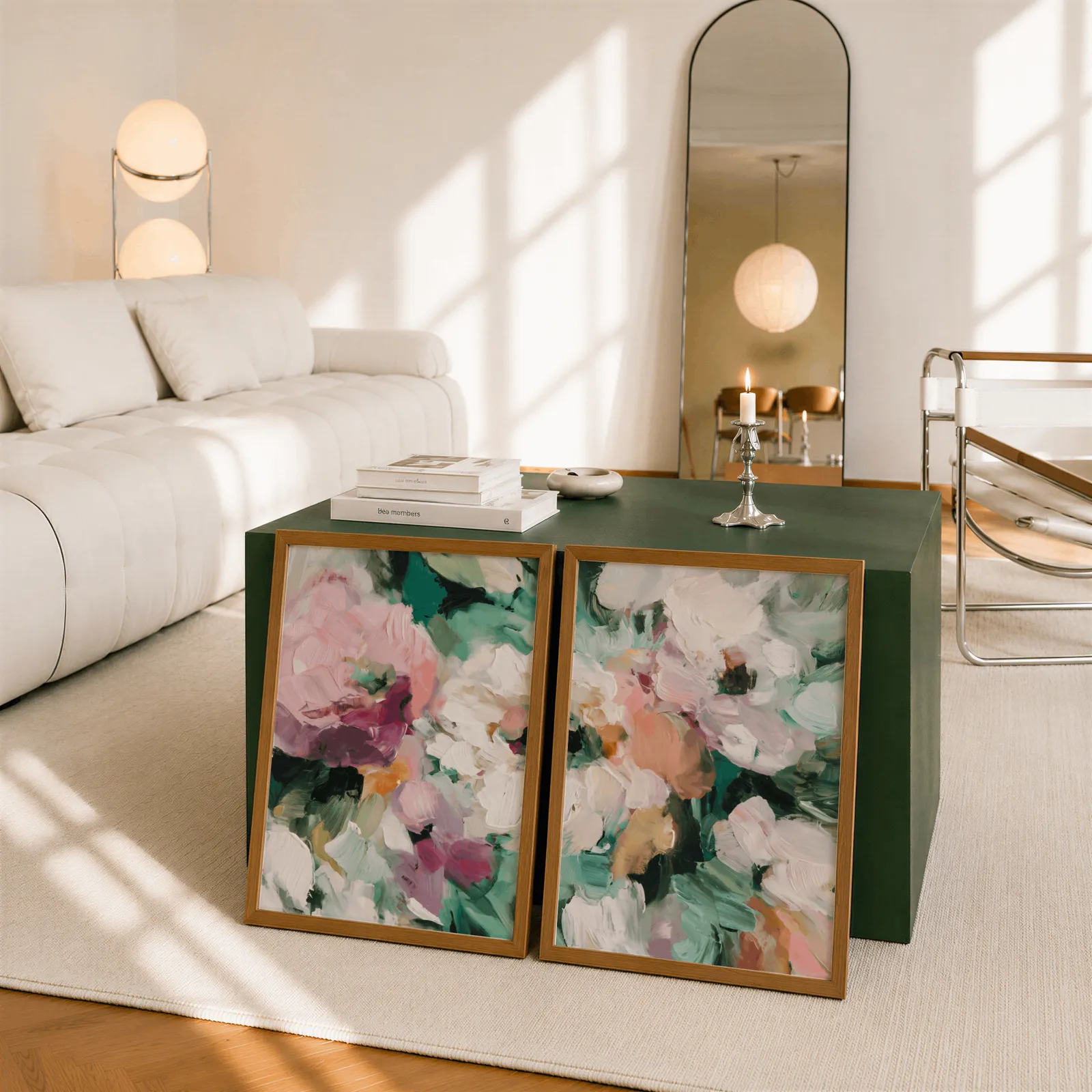 pink and green abstract floral wall art set of two, leaning against a dark green cube table beside an arched mirror