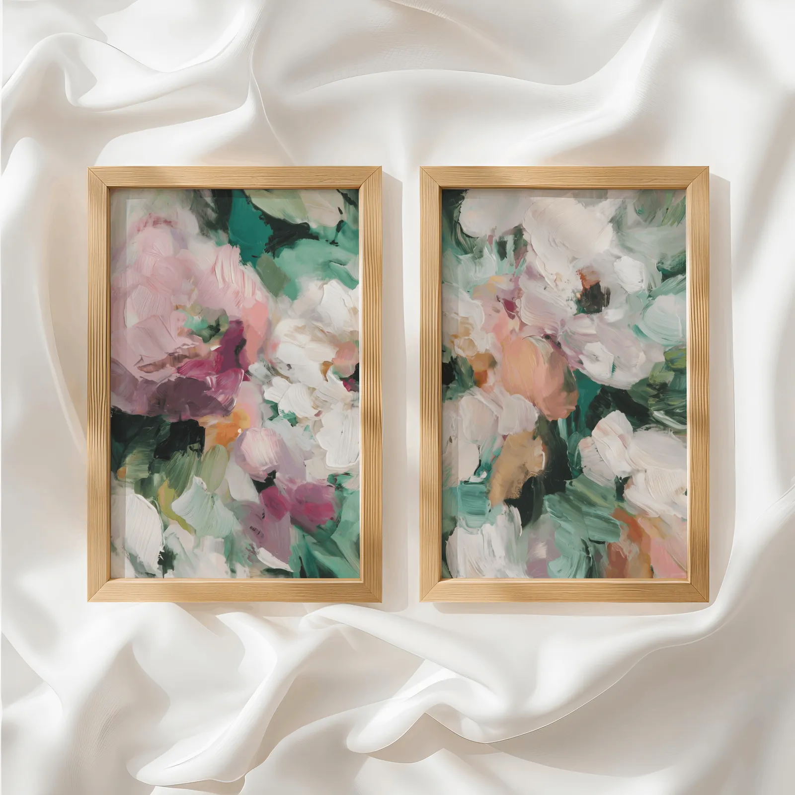 pink and green abstract floral wall art set of two, side by side atop rumpled white silky fabric