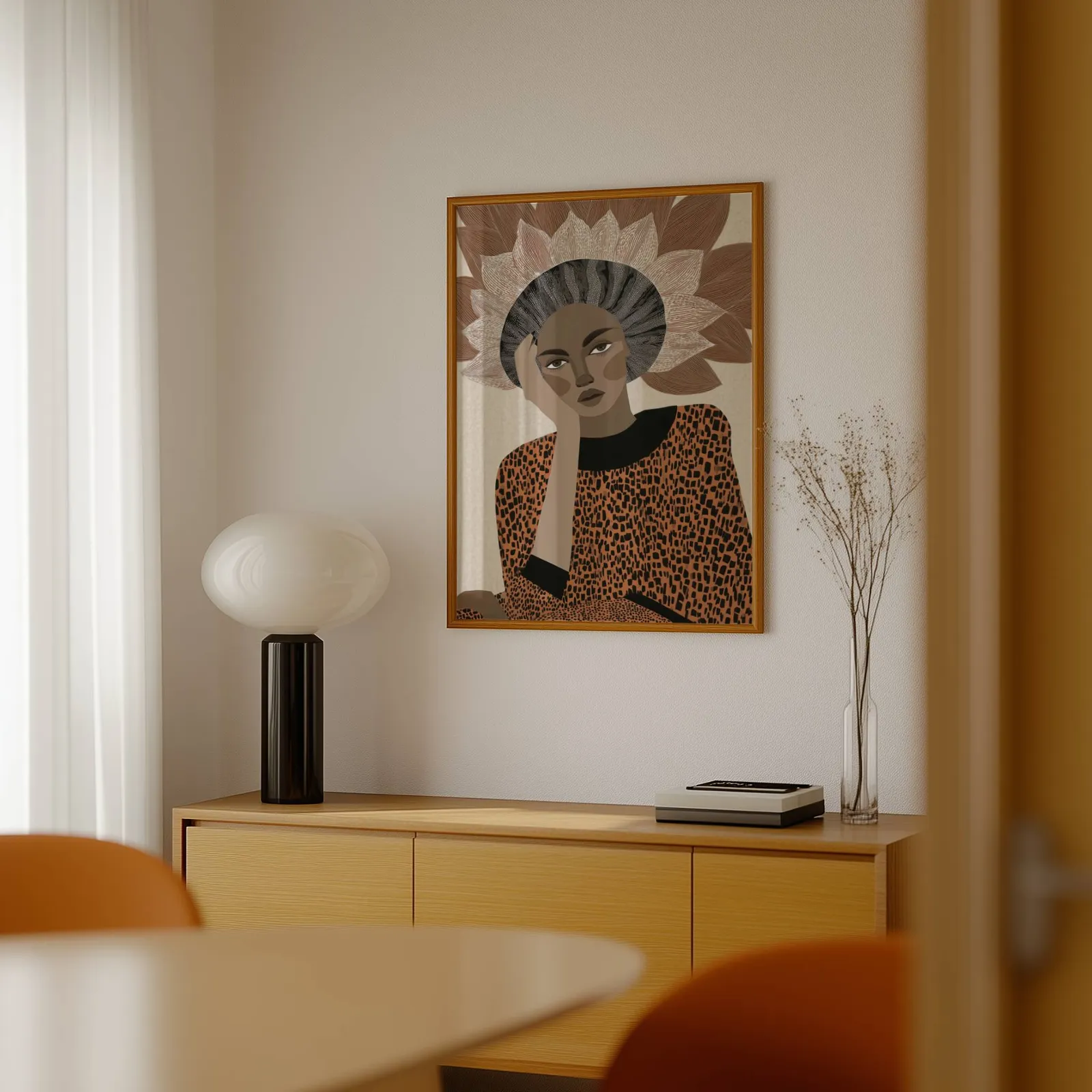 terracotta abstract woman portrait wall art with petal crown, above a light wood sideboard beside a bulbous black lamp