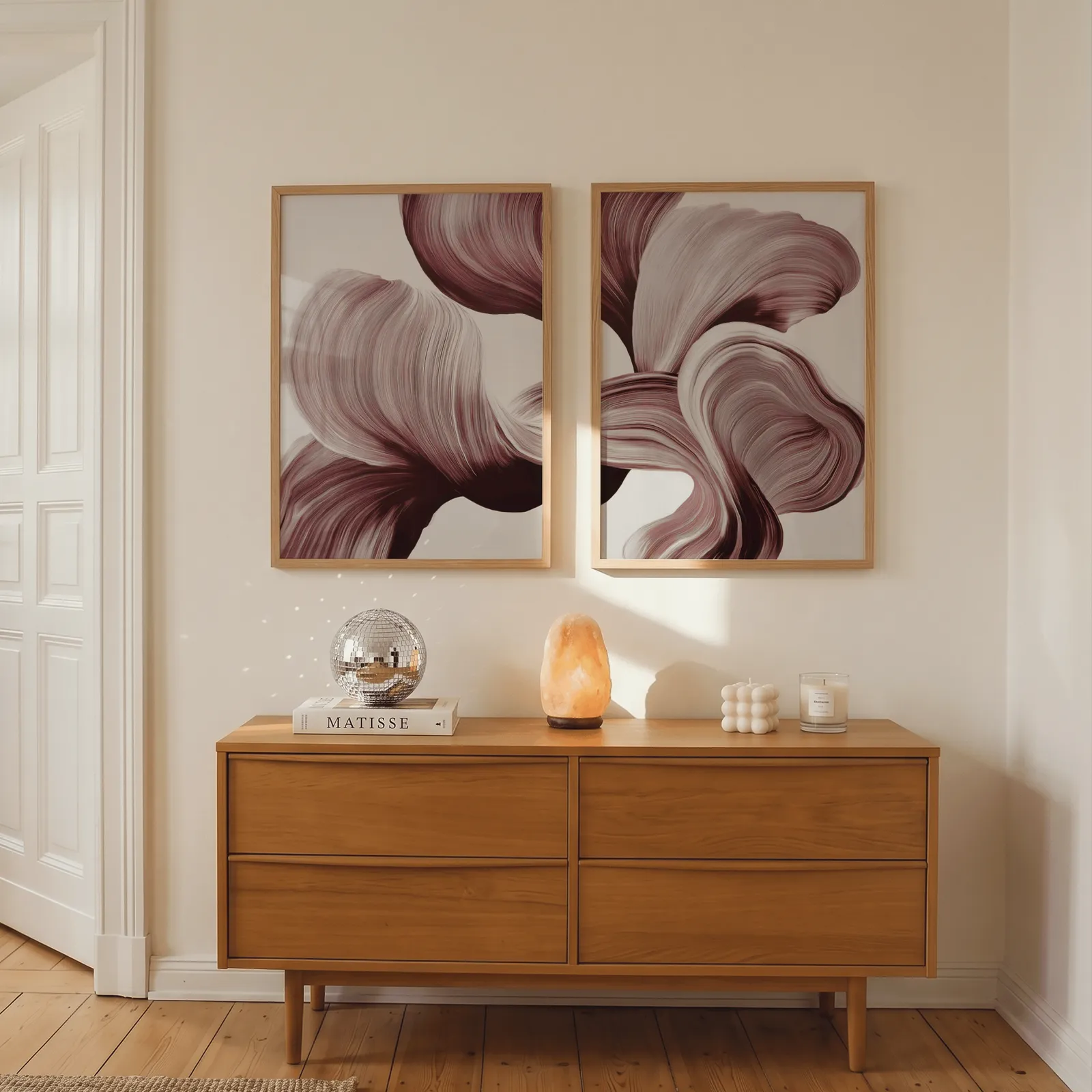 burgundy abstract floral wall art set of two, above a wooden dresser with a salt lamp and disco ball