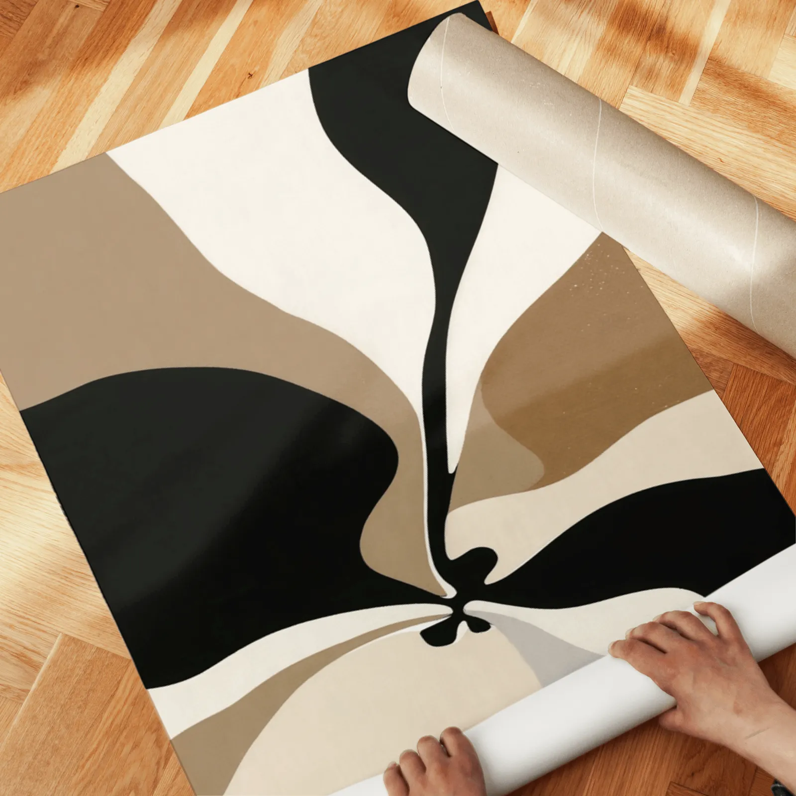 black and beige abstract wall art set of 2, unrolled across a herringbone parquet floor by hand