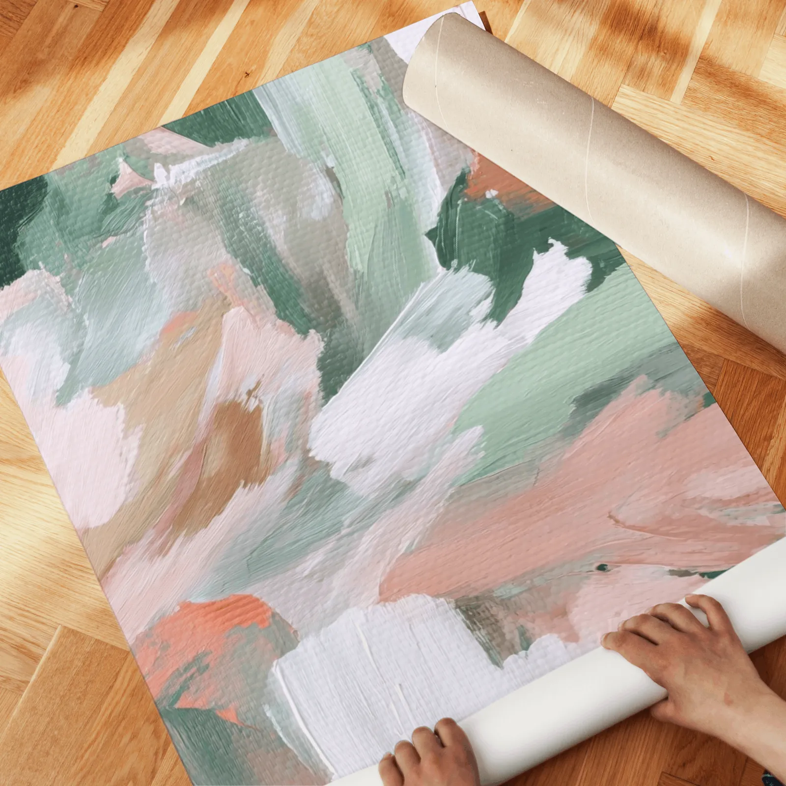 pink and green abstract floral wall art set of two, unrolled across a herringbone parquet floor by hand