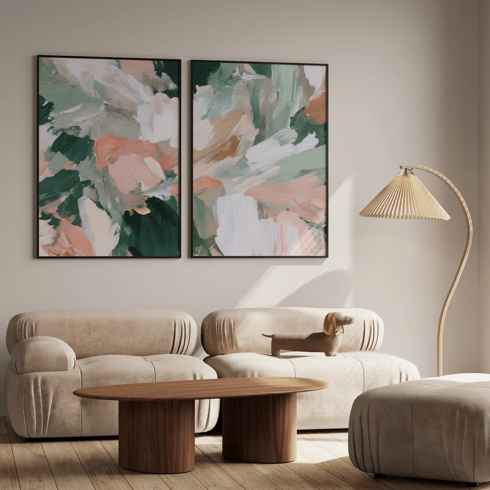 pink and green abstract floral wall art set of two, above a plush beige sofa with a pleated lamp nearby