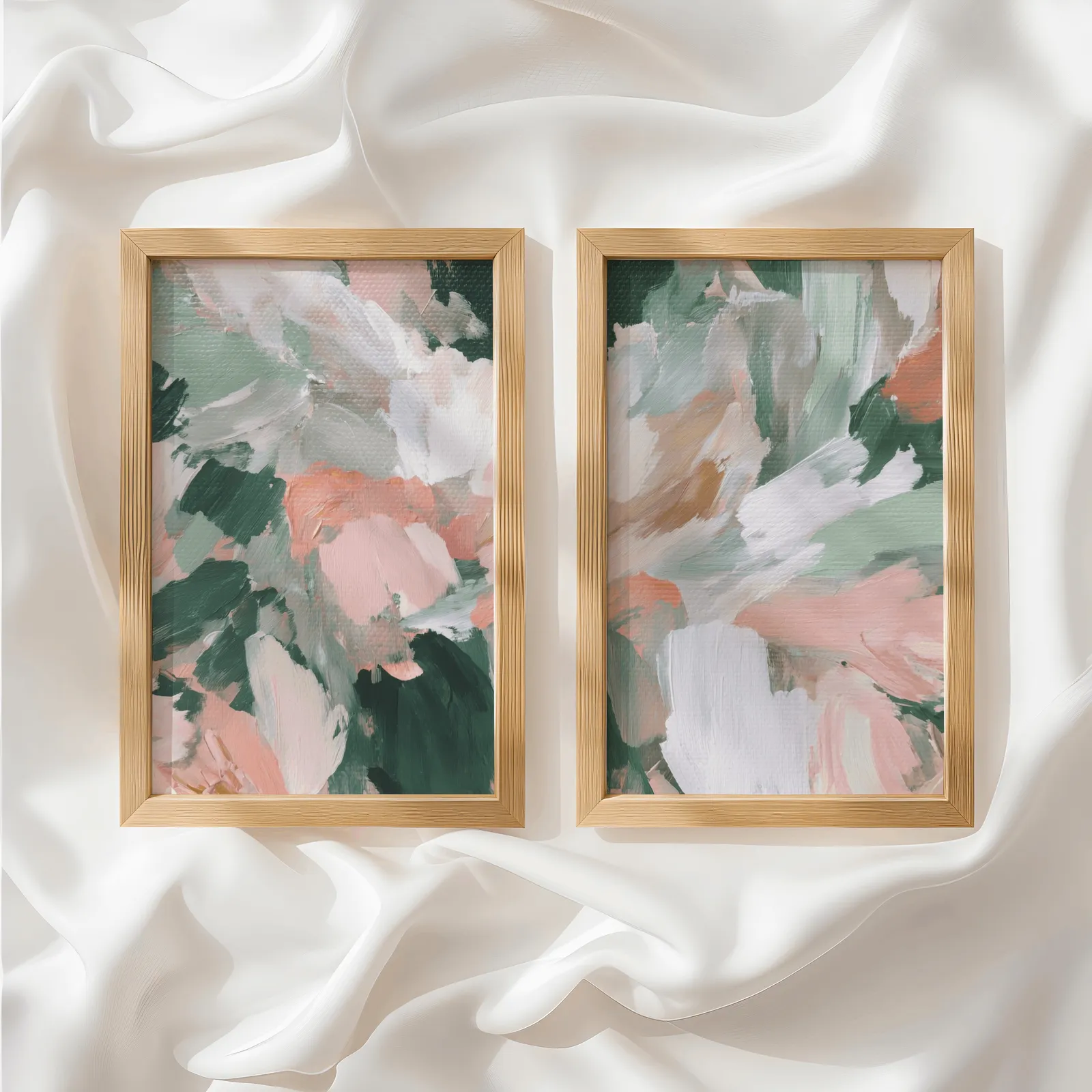 pink and green abstract floral wall art set of two, side by side atop rumpled white silky fabric