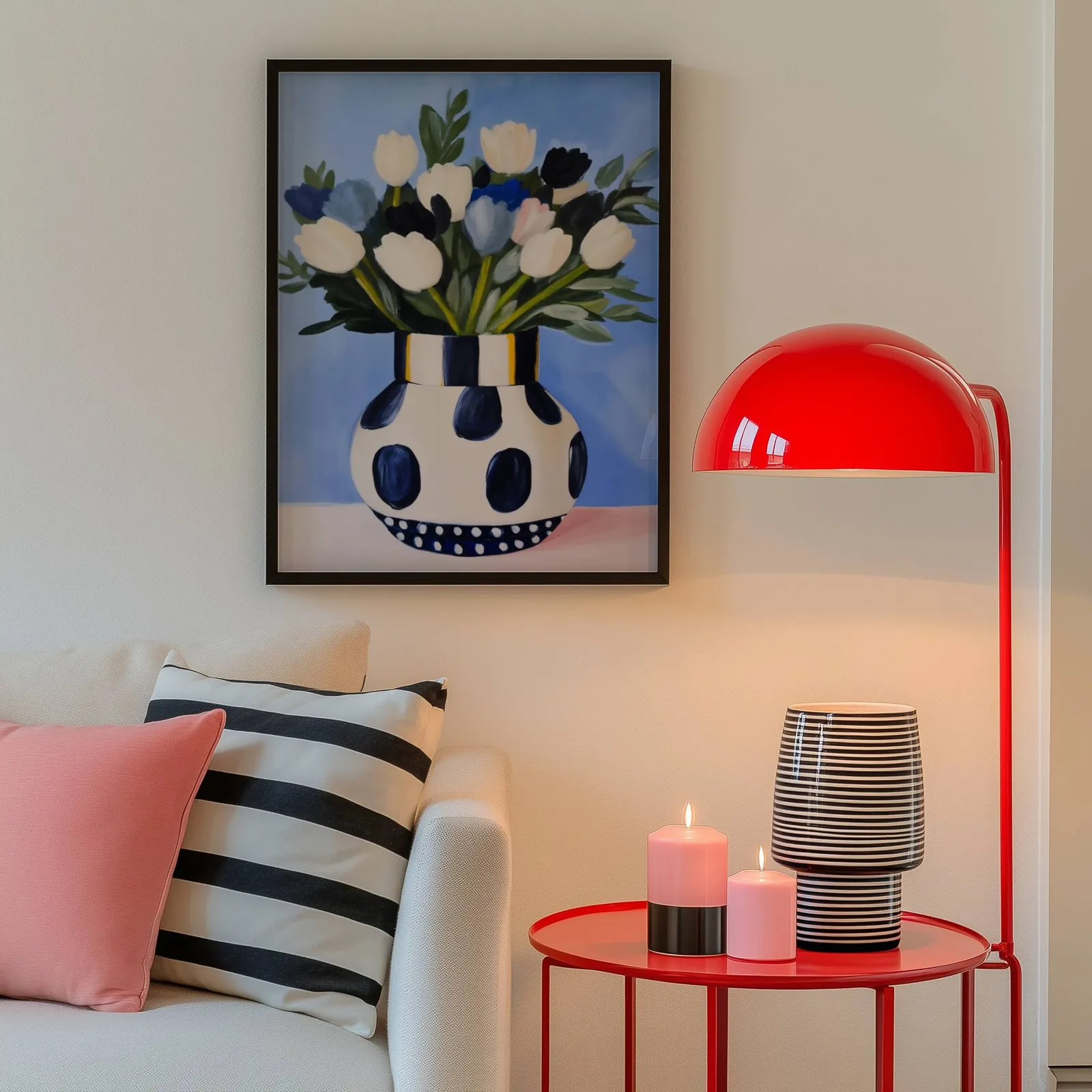 blue floral wall art with polka dot vase, above a cream sofa beside a glossy red dome lamp