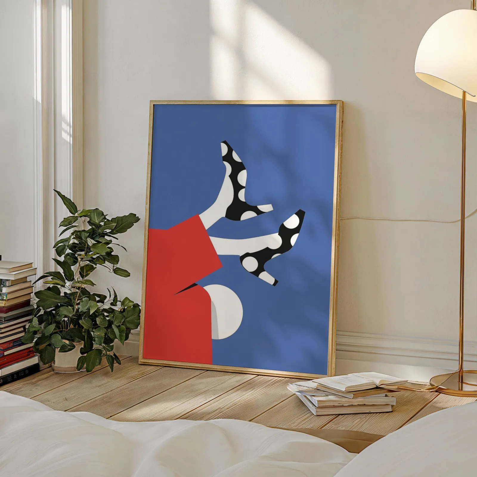 playful abstract woman wall art in red and blue, leaning against a sunlit wall beside a stacked bookshelf and fiddle-leaf plant