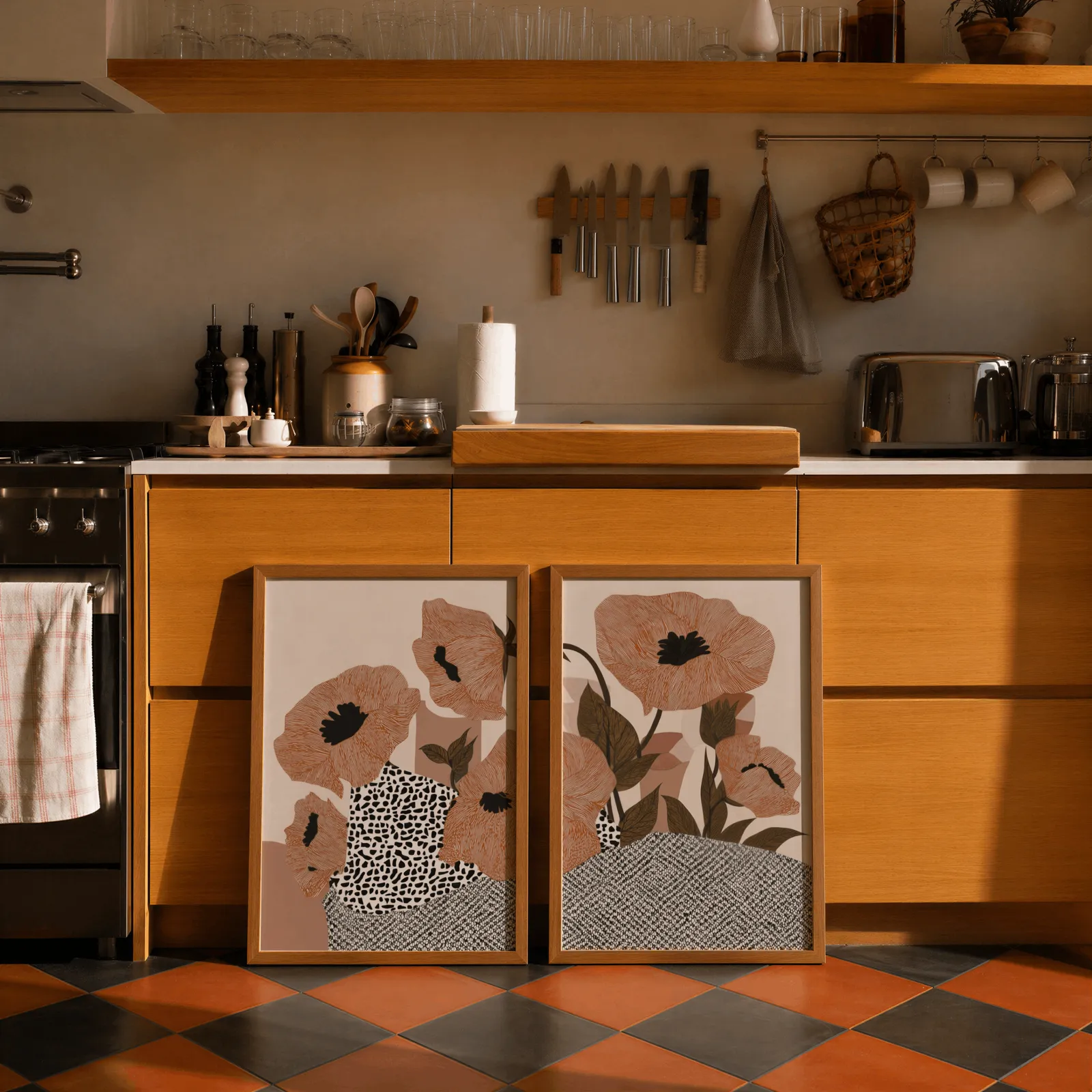 terracotta poppy botanical wall art set of two, leaning against wooden cabinets on terracotta tiled floor