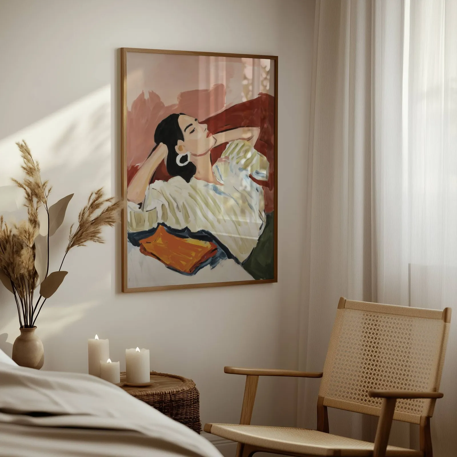 terracotta reclining woman portrait wall art, above a woven side table with lit candles and pampas grass